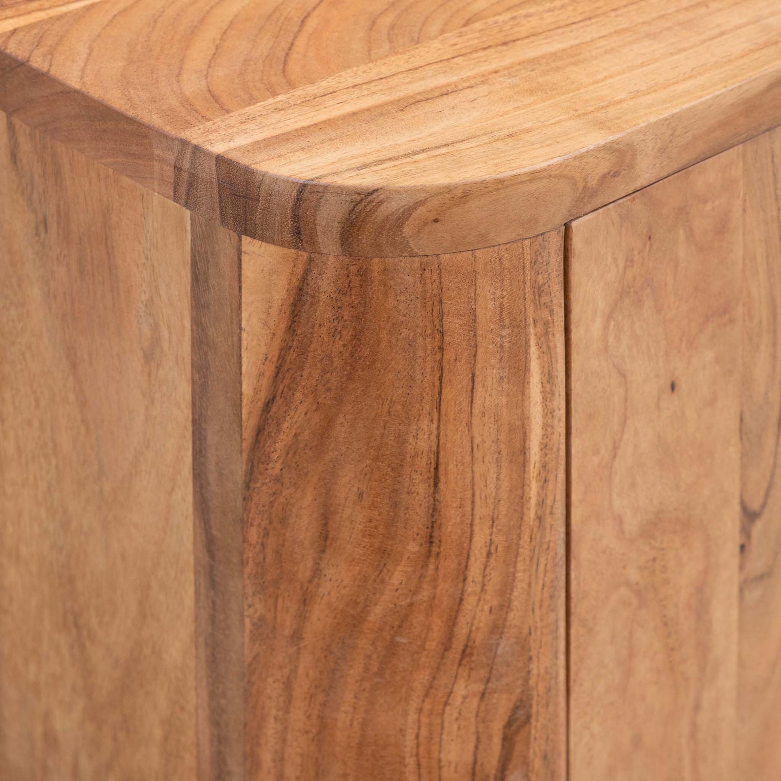 Close-up of the Leather Gallery Baltic Sideboard in Acacia wood, showing the curved top edge and natural wood grain texture.