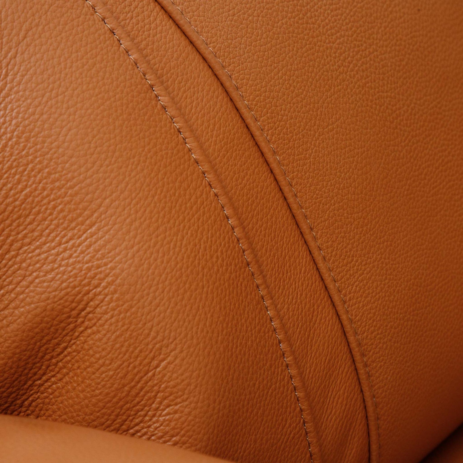 Close-up of the Leather Gallery Carter 1 Seater Leather Recliner Chair in Tan, showing the natural leather grain and curved seam detail.