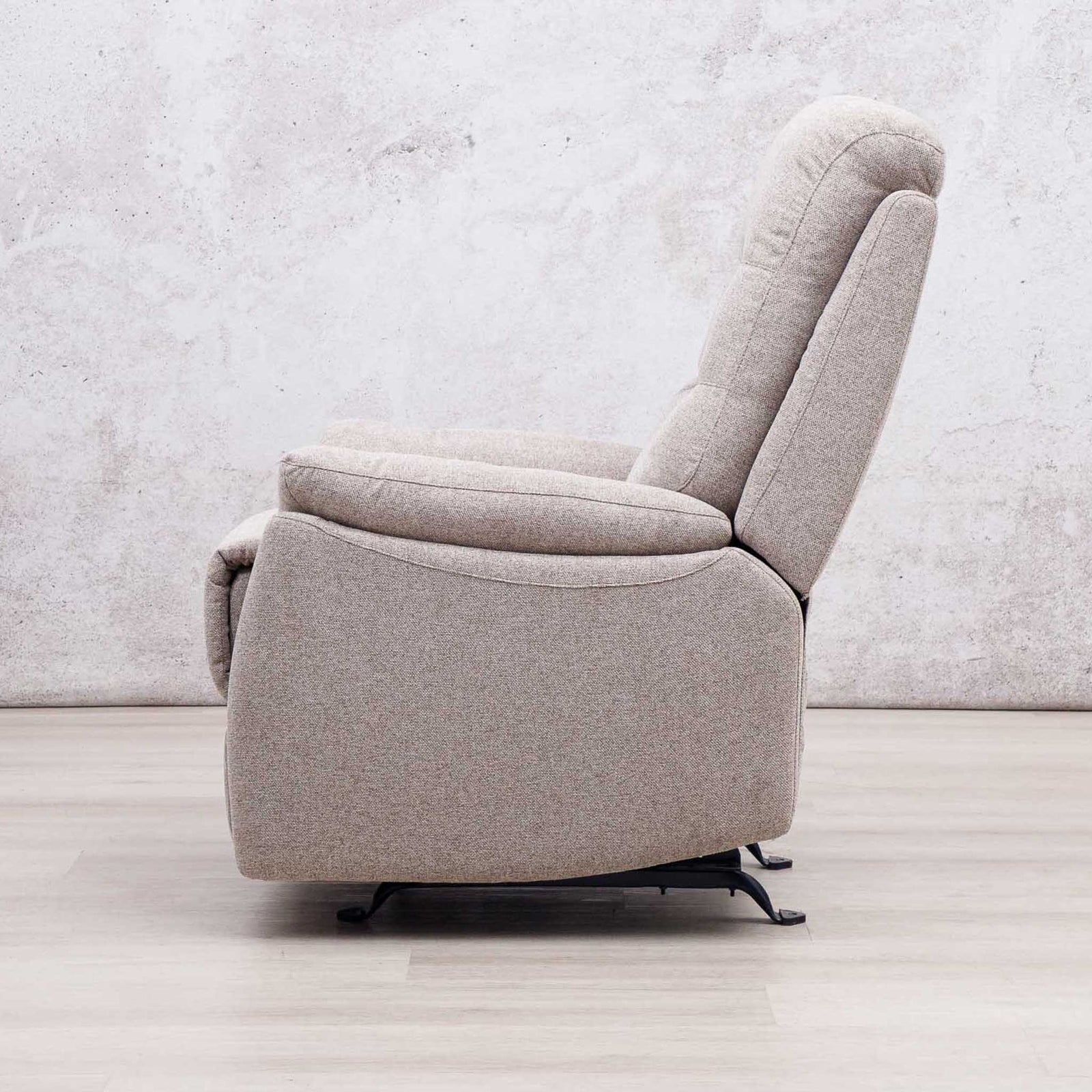Side view of the Leather Gallery Dallas Fabric Rocker Recliner Chair in Beige, showing its upholstered recliner profile.