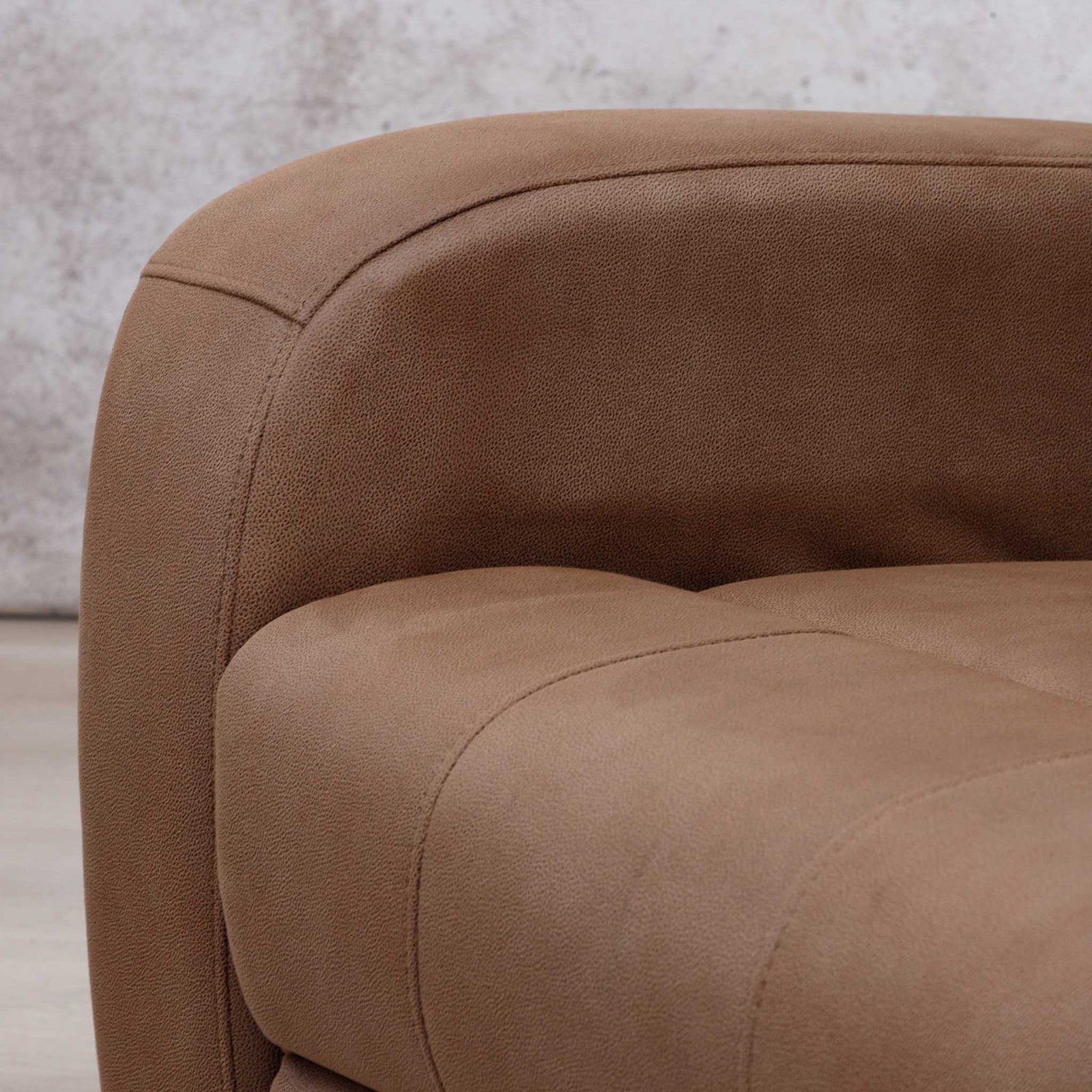 Close-up of the Leather Gallery Orlando 3 Seater Fabric Recliner in Desert Sand, showing the curved armrest, cushioned seat, and textured fabric upholstery.