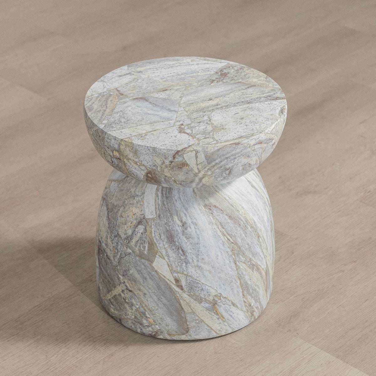 Gallery Everyday Ostia Side Table in Aqua Mist, featuring a round stone top and sculptural pedestal base with a blue-grey and cream finish.
