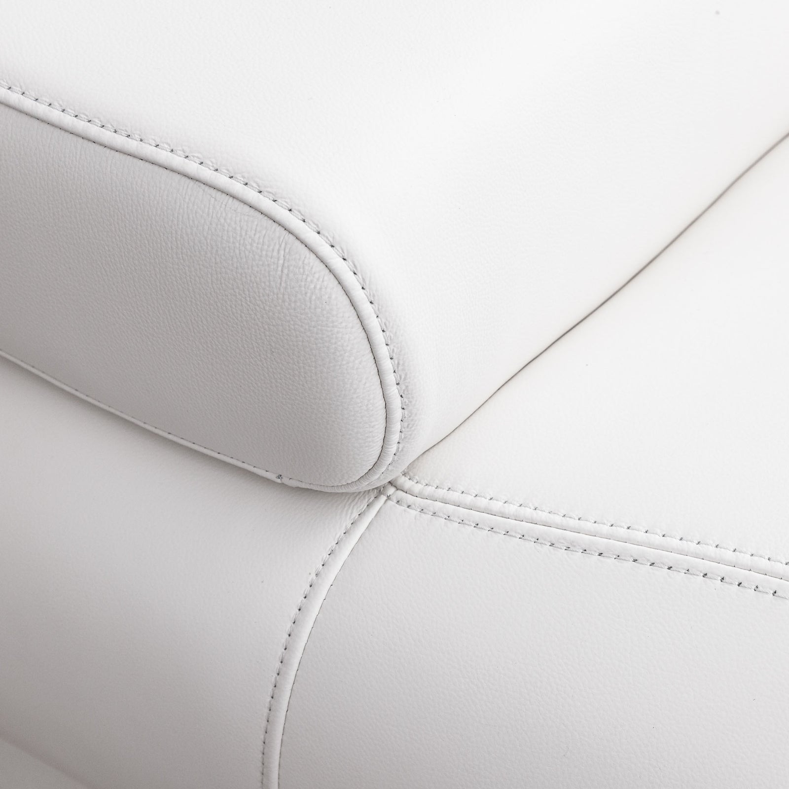 Close-up of the Leather Gallery Tobago 5 Seater L Shape Sectional in white, showing the textured leather armrest, seat corner, and precise stitching.
