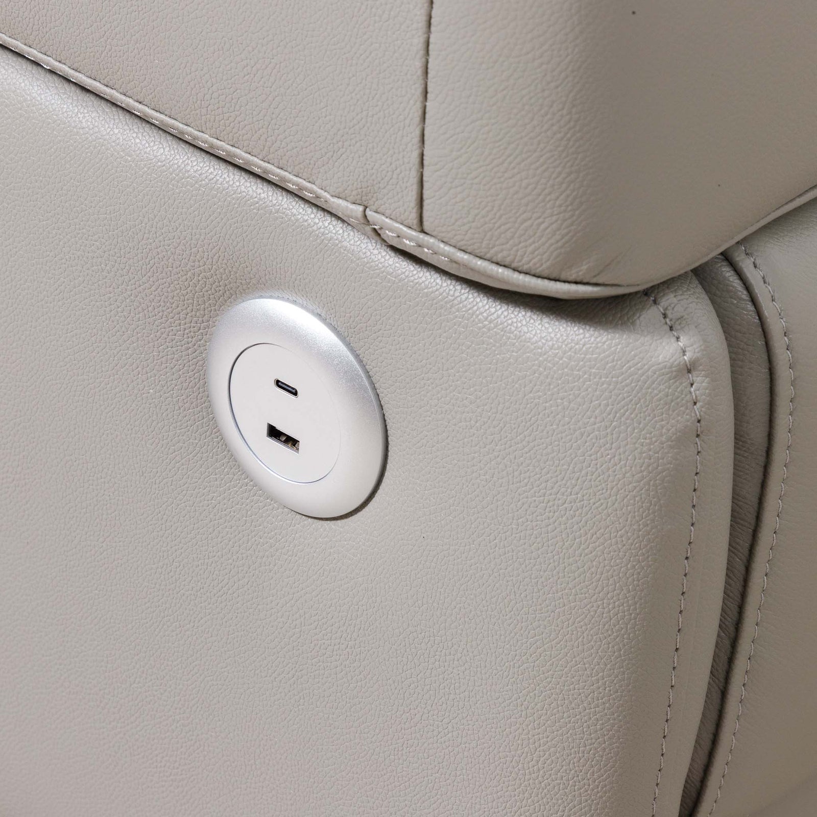 Close-up of the Leather Gallery Tobago 5 Seater Leather L Shape Couch in Grey, showing the circular silver USB charging outlet.
