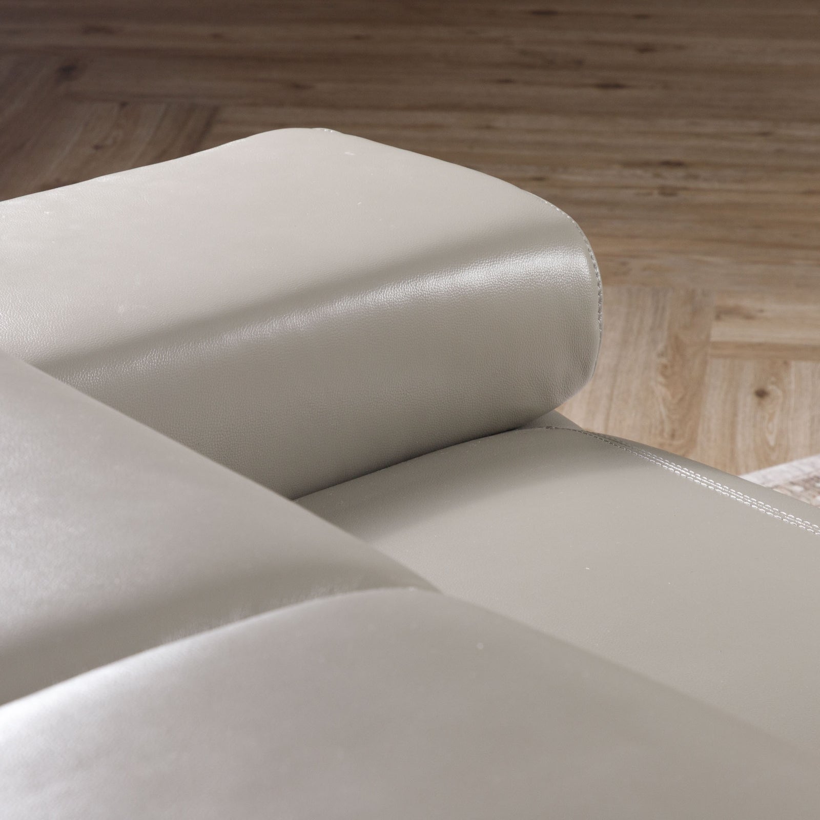 Close-up of the Leather Gallery Tobago 5 Seater Leather L Shape Couch in Grey, showing the curved armrest and smooth leather upholstery.
