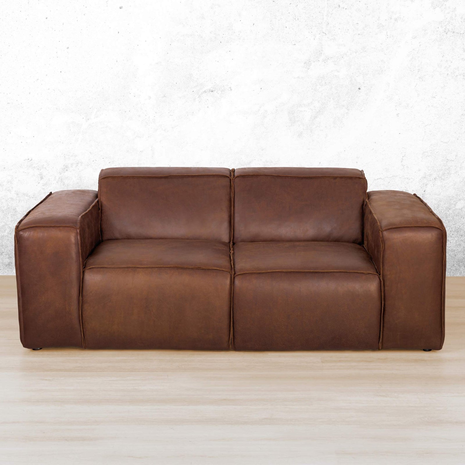 Austin 2 Seater Leather Couch in Woodlands Spice, in a bright, modern-minimalist styled living room. Genuine leather couches.