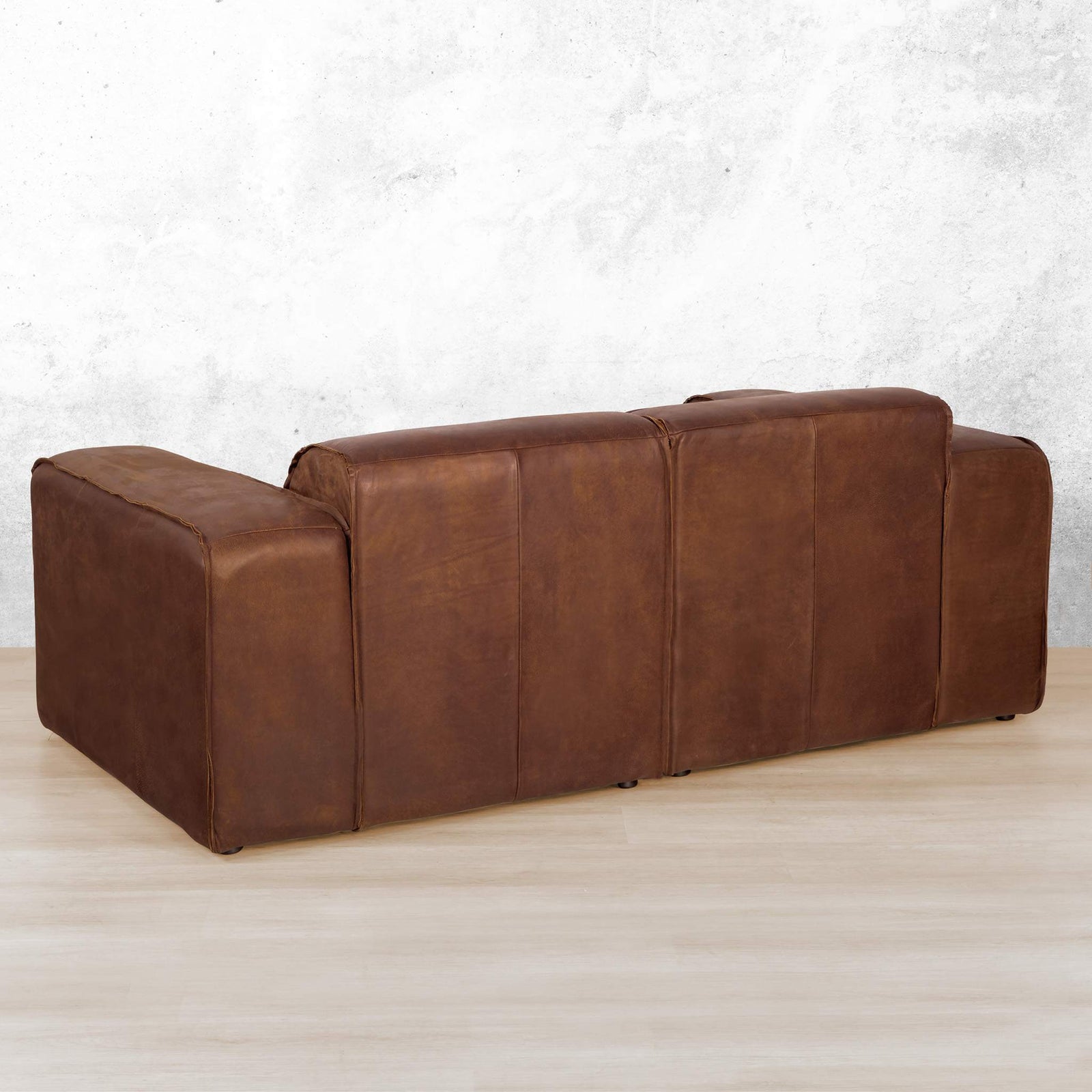 Austin 2 Seater Leather Couch in Woodlands Spice, in a bright, modern-minimalist styled living room. Genuine leather couches.