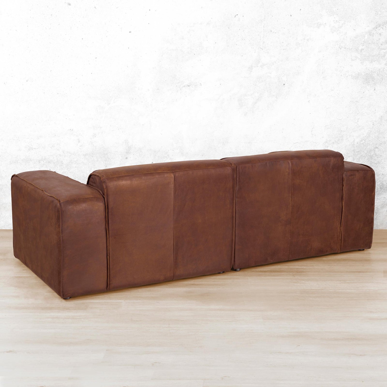 Austin 3 Seater Leather Couch in Woodlands Spice, in a bright, modern-minimalist styled living room. Genuine leather couches.