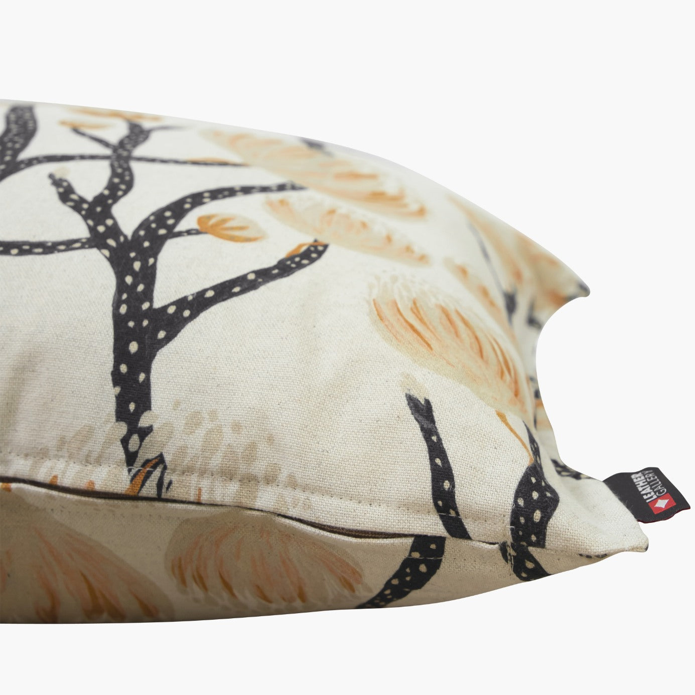 Side view of a high-quality Fynbos Protea chair cushion showing the textured fabric and Leather Gallery brand tag. | Leather Gallery Scatter Cushions