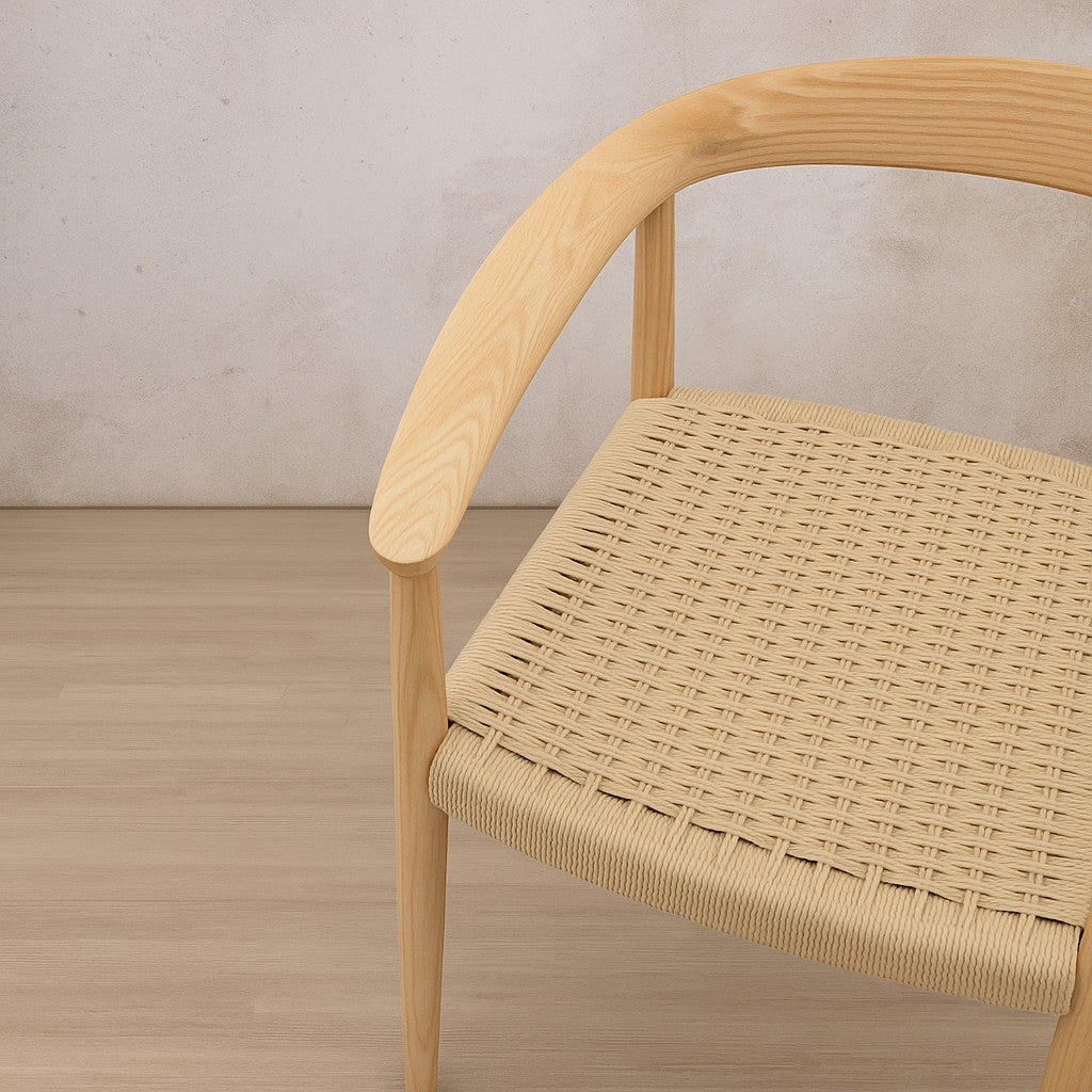 Close-up of the handwoven rope seat on the Easton wood dining chair, showing the intricate twine pattern.