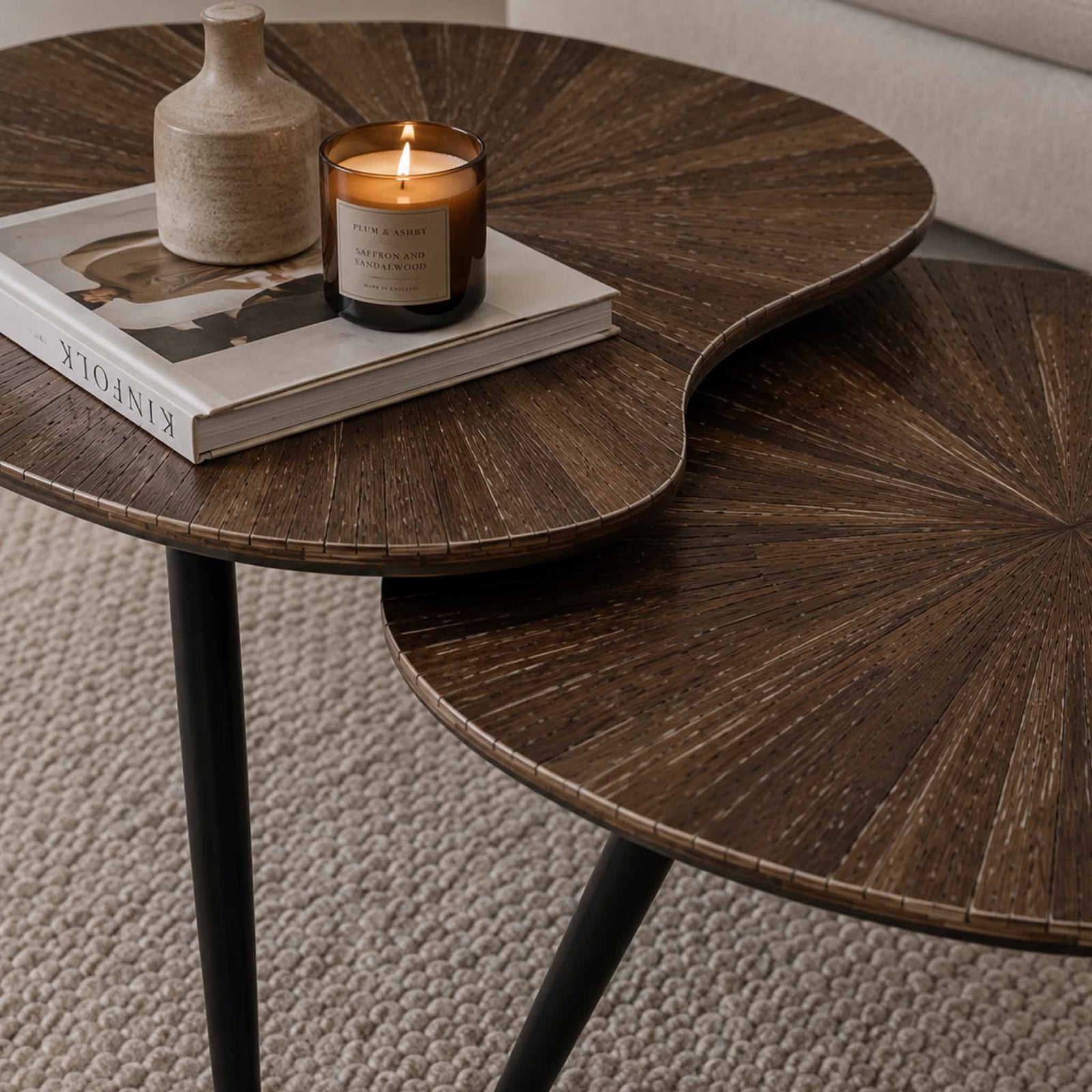 Gallery Everyday Eden Nesting Coffee Tables Set of 2, featuring dark brown sunburst wood-grain tops and black metal legs.