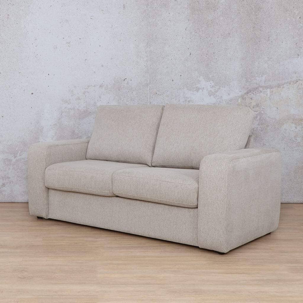 Angled view of Leather Gallery’s Stanford fabric sleeper couch, showcasing its modern design. This stylish sleeper couch offers both comfortable seating and a guest bed option. oyster