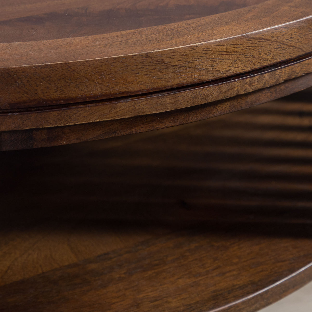 Detailed view of the natural wood grain and slatted base of the Cassis round coffee table, highlighting the craftsmanship and material.