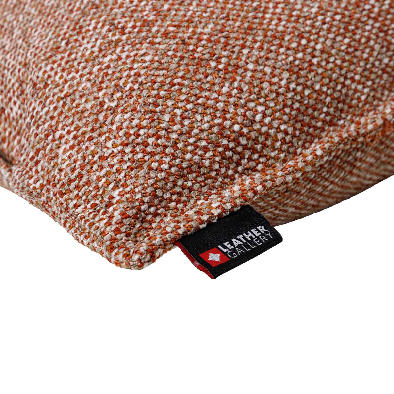 Close-up of the Leather Gallery Aardé Cushion in Sienna Rust, showing the textured herringbone weave and branded Leather Gallery tag.