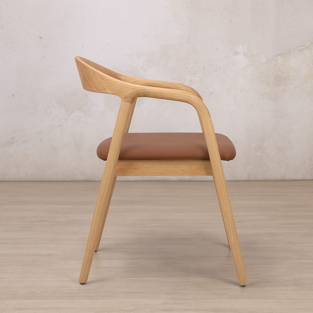 Alden Natural Leather Dining chair side view showing its sloped legs and curved backrest. | wooden dining chair, armchair, carver dining chairs 