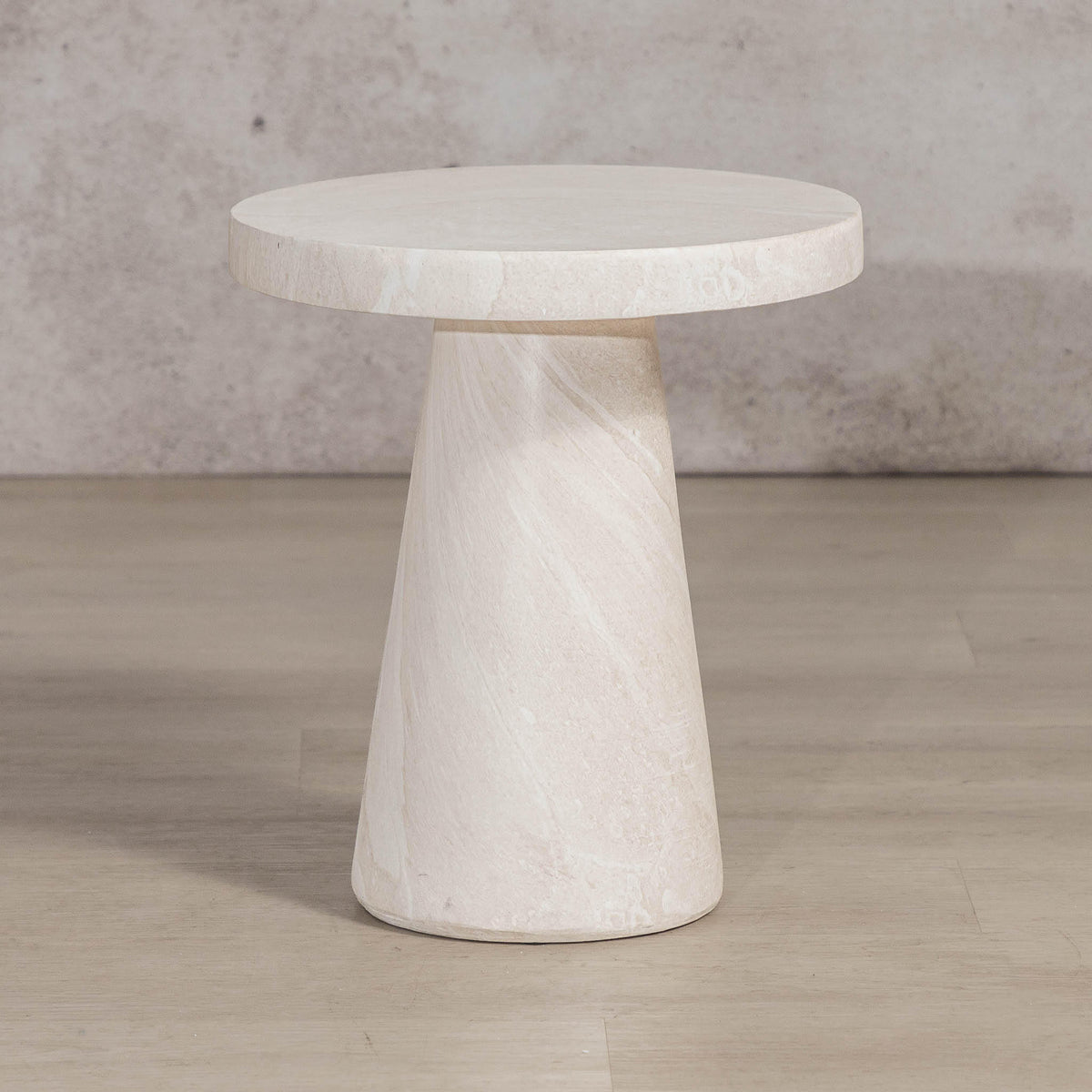 Gallery Everyday Angelo Side Table in Lunar Quartz, featuring a round stone top and tapered pedestal base in a bright modern living room.