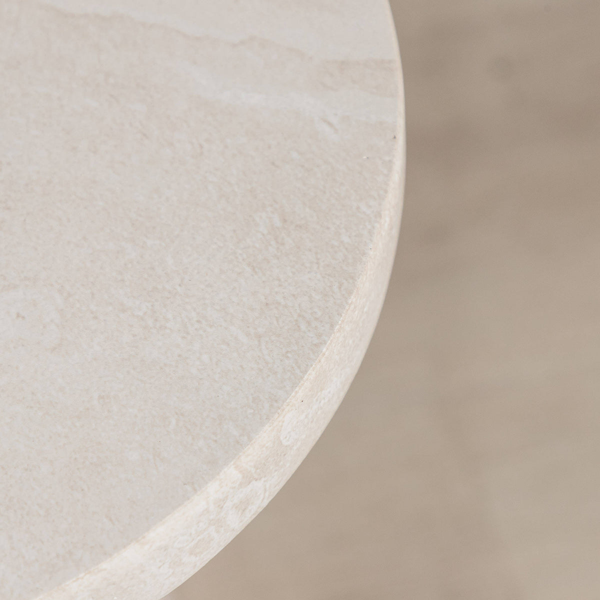 Gallery Everyday Angelo Side Table in Lunar Quartz, featuring a round stone top and tapered pedestal base in a bright modern living room.