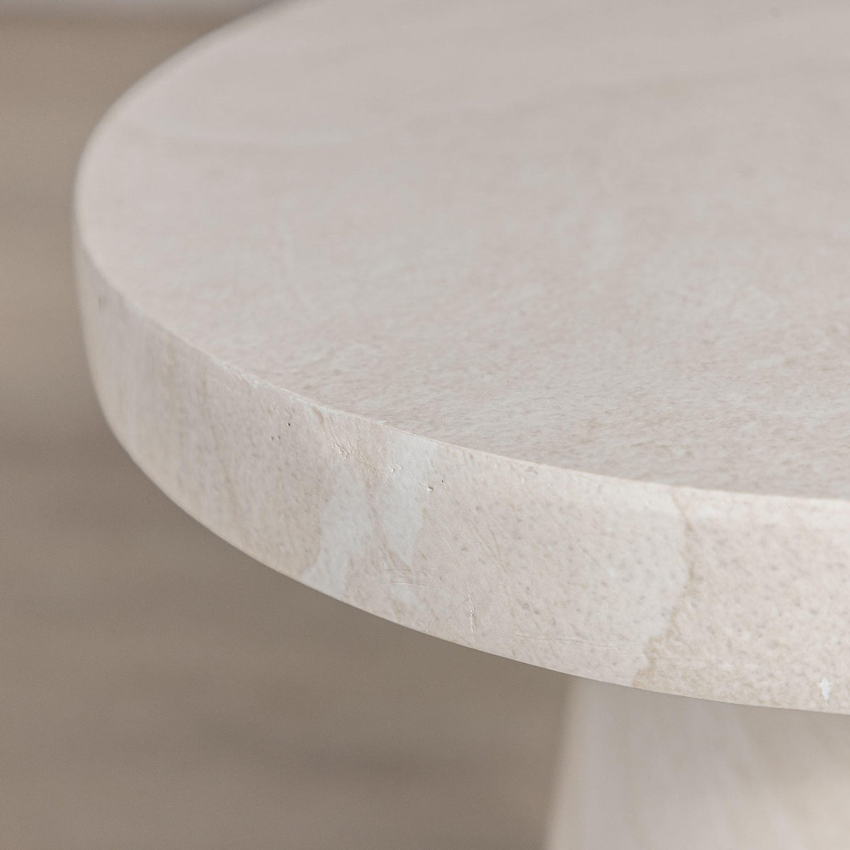 Gallery Everyday Angelo Side Table in Lunar Quartz, featuring a round stone top and tapered pedestal base in a bright modern living room.