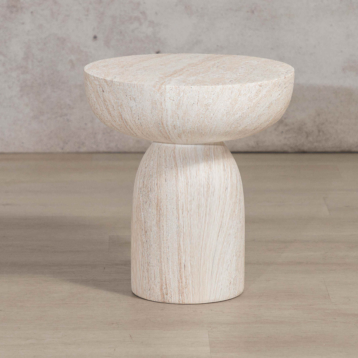 Gallery Everyday Aquila Side Table in Seashell, featuring a round travertine-look top and pedestal base in a warm beige finish.