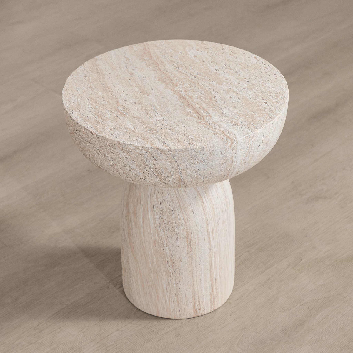 Gallery Everyday Aquila Side Table in Seashell, featuring a round travertine-look top and pedestal base in a warm beige finish.