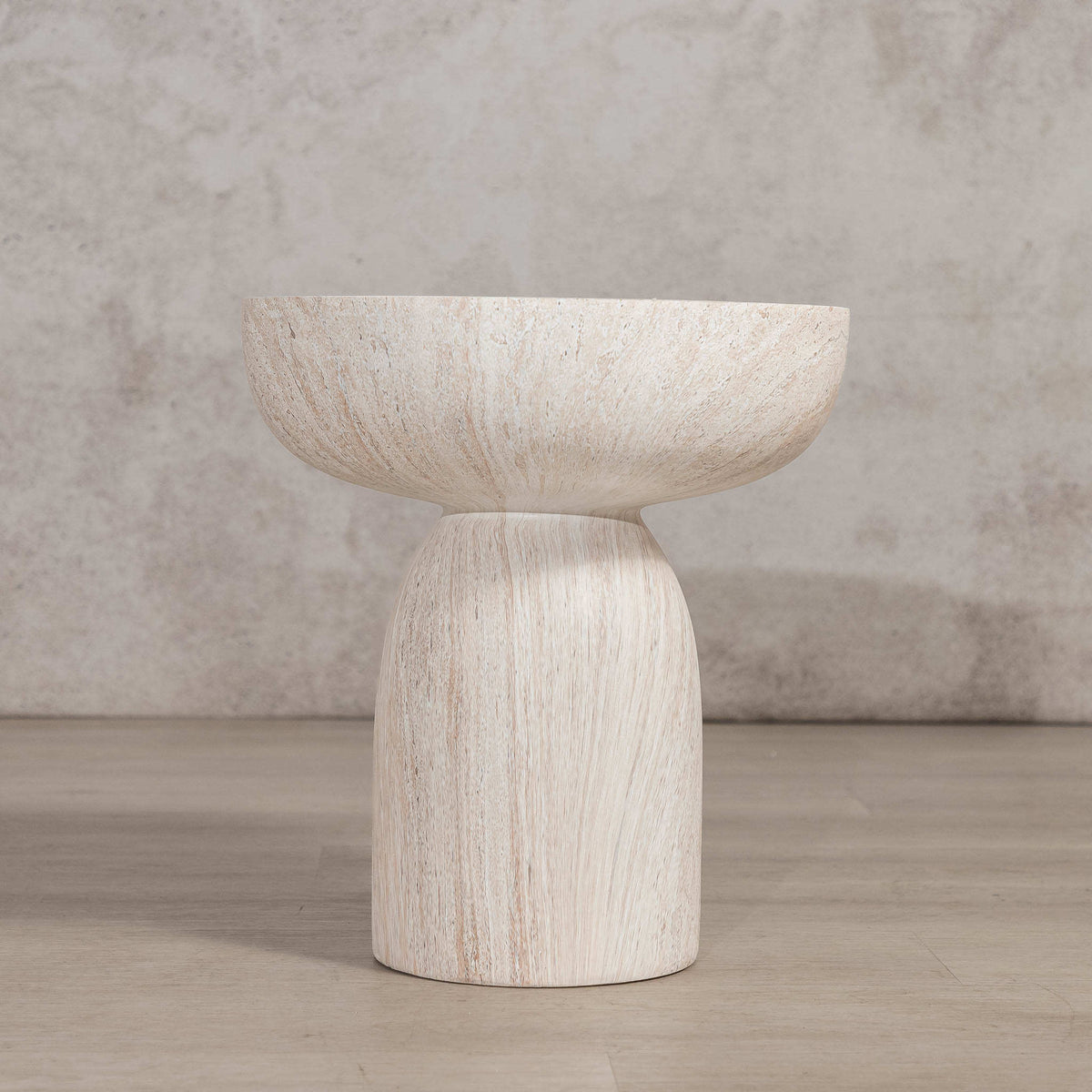 Gallery Everyday Aquila Side Table in Seashell, featuring a round travertine-look top and pedestal base in a warm beige finish.