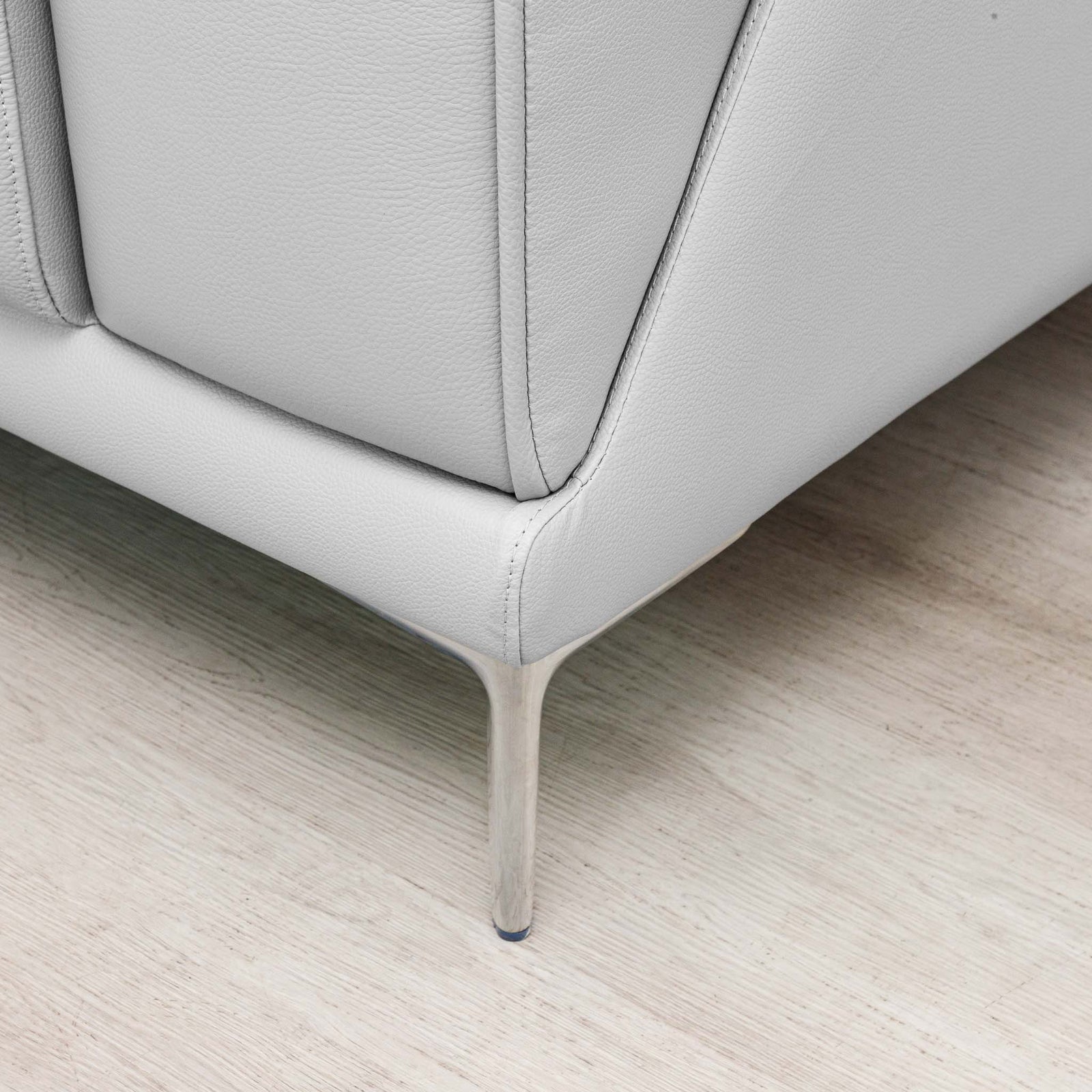 Close-up of the Leather Gallery Atlanta 1 Seater Leather Couch in Luxe Beige, showing the upholstered corner and slim metal leg.
