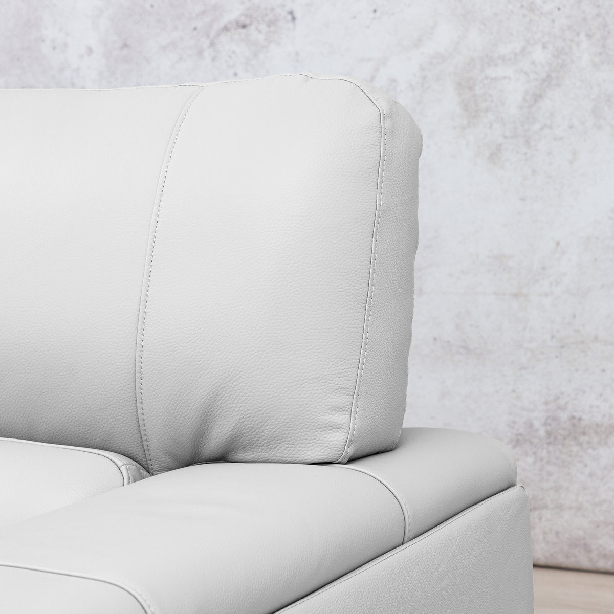 Close-up of the Leather Gallery Atlanta 2 Seater Leather Couch in Luxe Beige, showing the back cushion, armrest, and stitching detail.