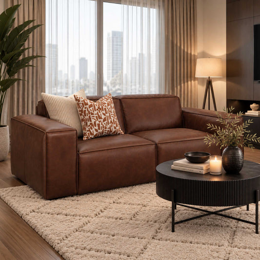Leather Gallery Austin 2 Seater Leather Couch in rich brown, styled in a contemporary living room with a side table and scenic window view. woodlands spice