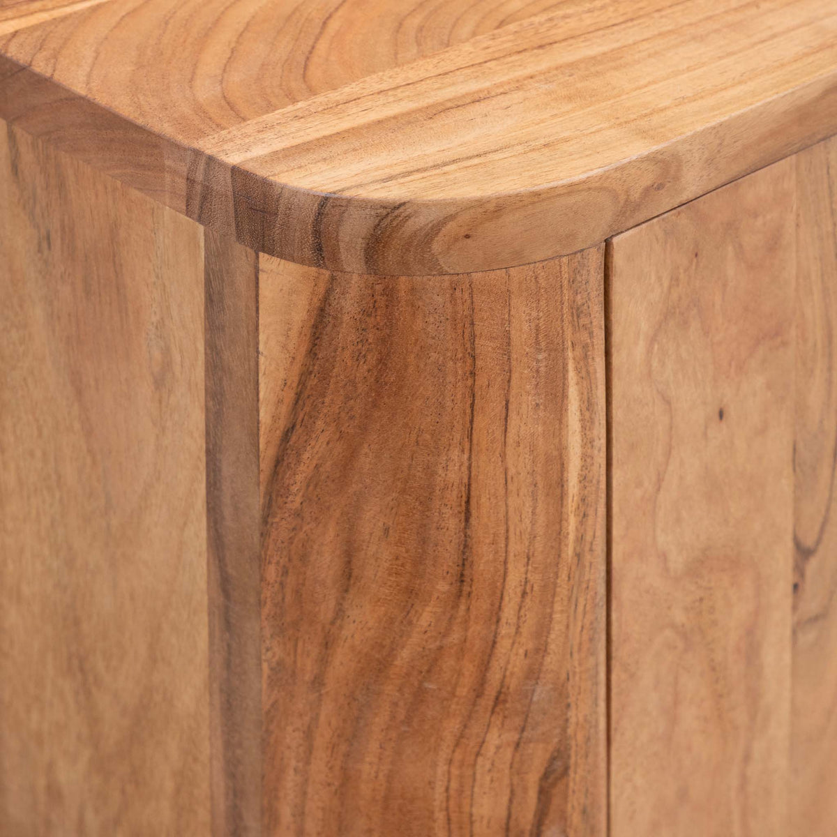 Close-up of the Leather Gallery Baltic Sideboard in Acacia wood, showing the curved top edge and natural wood grain texture.