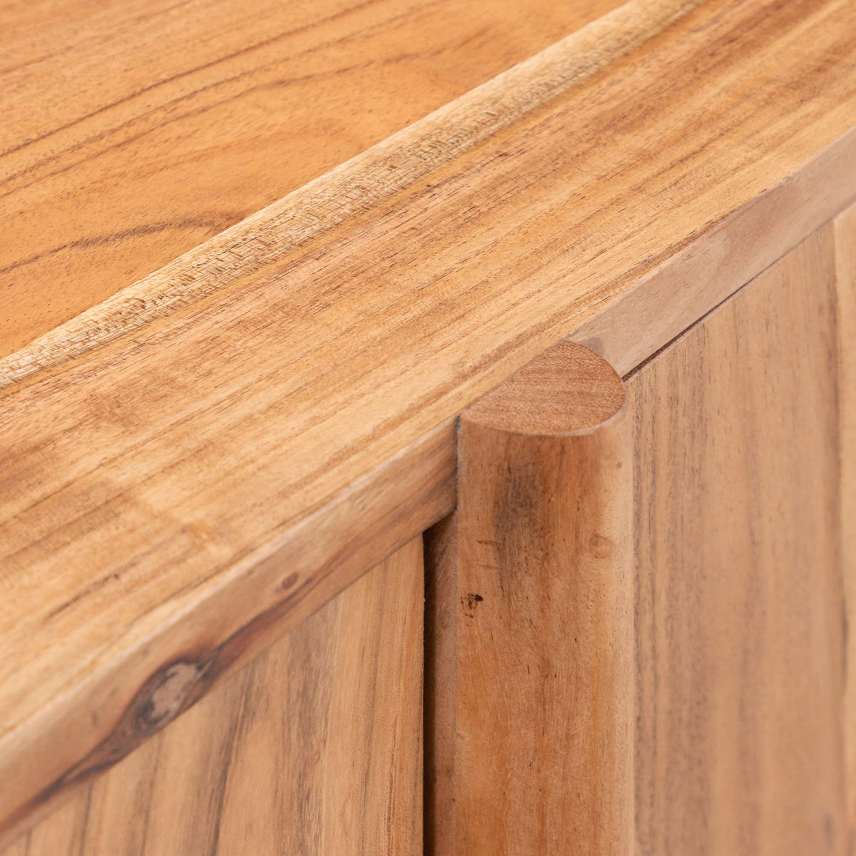 Close-up of the Leather Gallery Baltic Sideboard in Acacia wood, showing the top edge, front panel, peg joint, and natural wood grain.