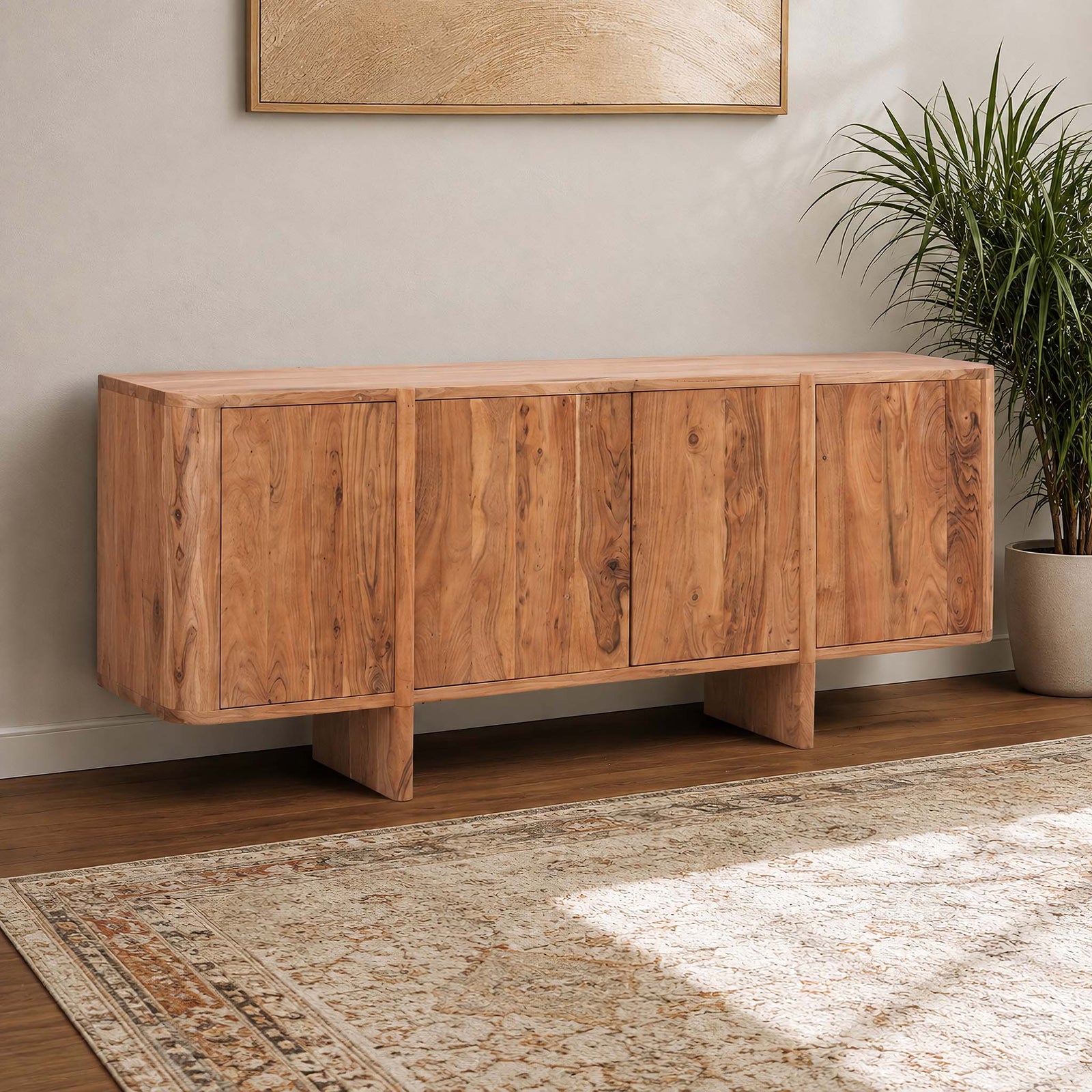 Gallery Everyday Baltic Sideboard in Natural Acacia wood, styled in a living room with a potted plant and patterned rug.