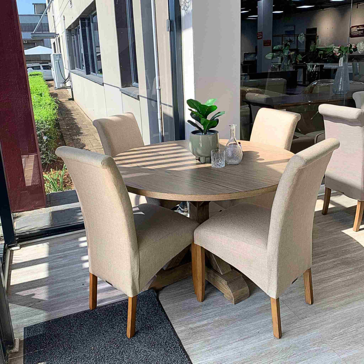 Leather Gallery Berkeley Round 4 Seater & Windsor Dining Set, featuring a round wooden table with four beige dining chairs.