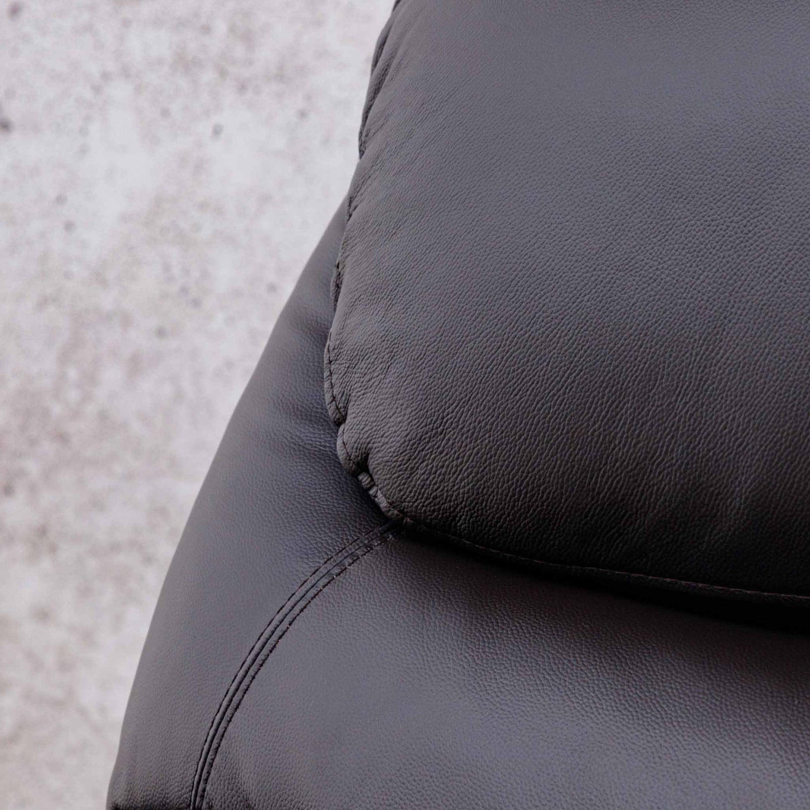 Close-up of the Leather Gallery Cairo 1 Seater Leather Recliner in Choc, showing the pebbled leather texture, cushion, and visible stitching.