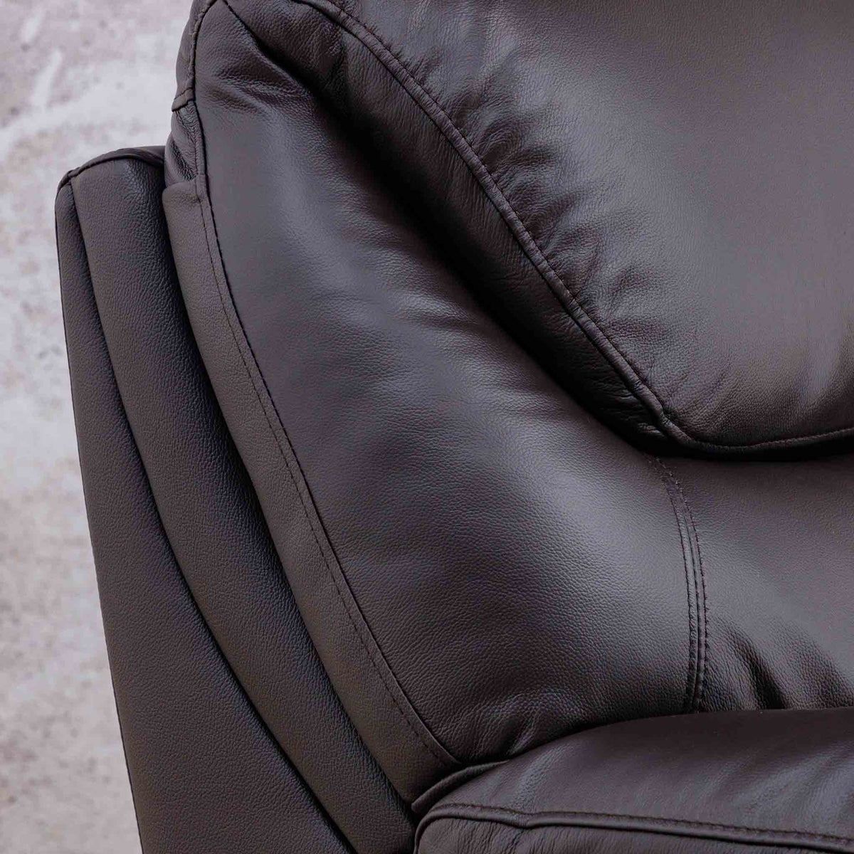 Close-up of the Leather Gallery Cairo 1 Seater Leather Recliner in Choc, showing the textured leather upholstery, stitching, and cushion details.