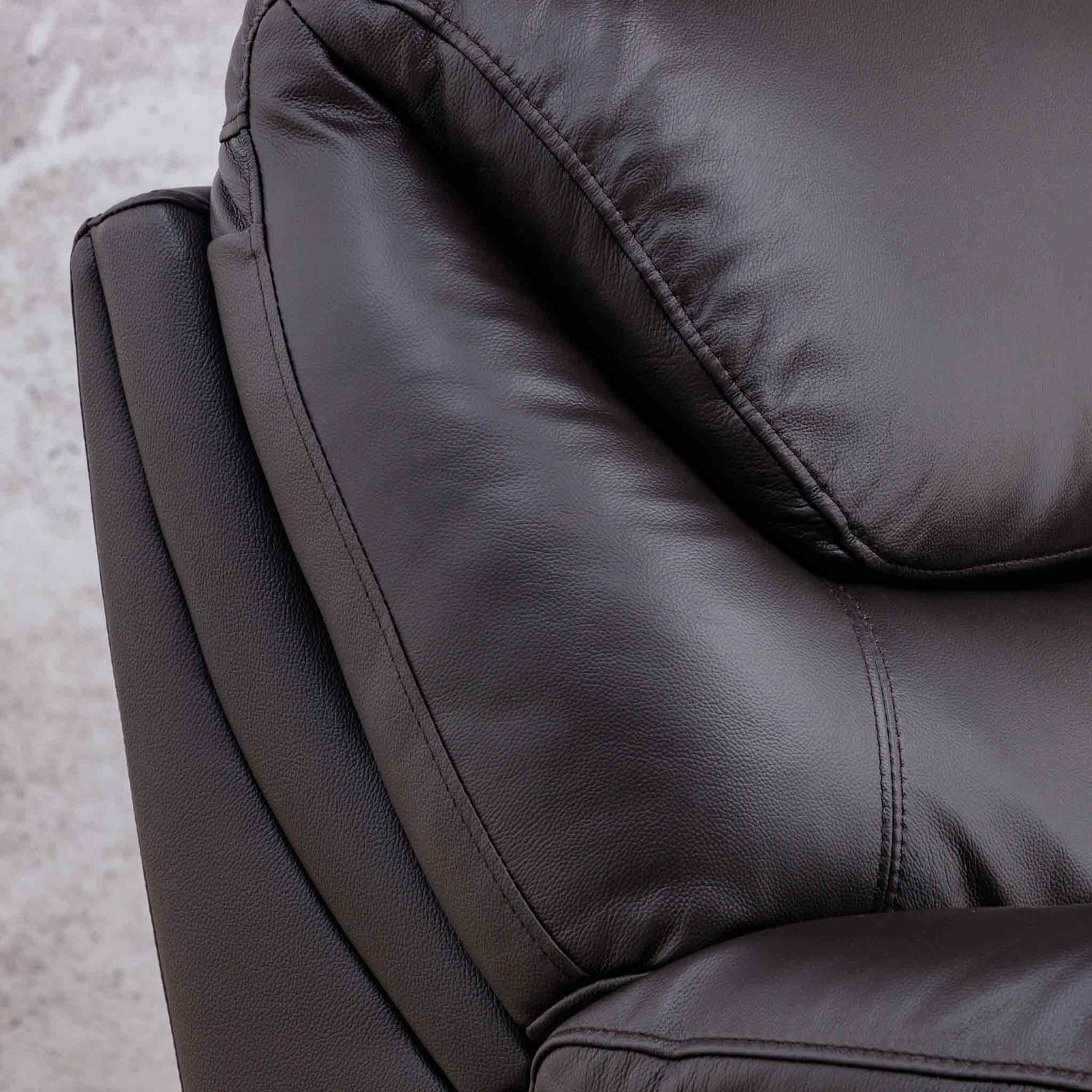 Close-up of the Leather Gallery Cairo 1 Seater Leather Recliner in Choc, showing the textured leather upholstery, stitching, and cushion details.