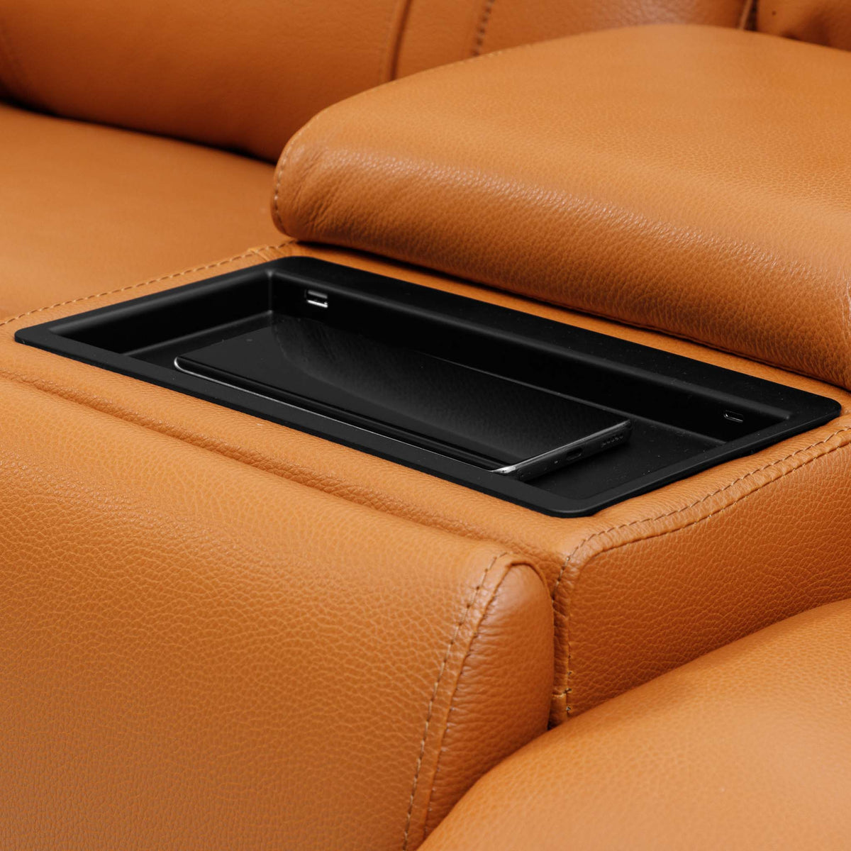 Close-up of the Leather Gallery Carter 1 Seater Leather Recliner Chair in Tan, showing the built-in black tray compartment and matching leather armrest.