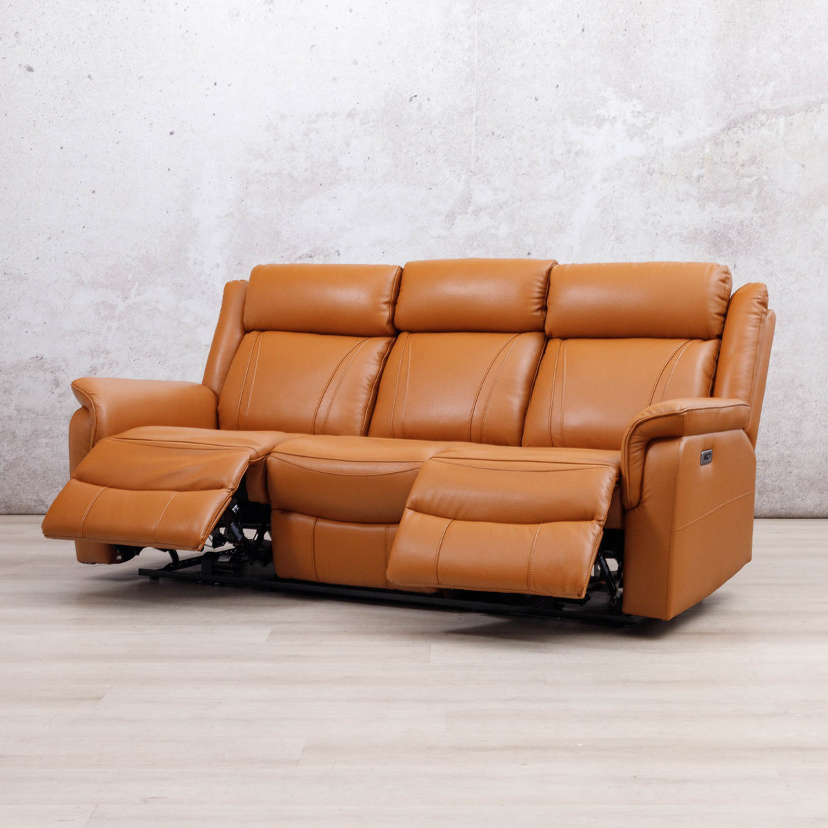 Leather Gallery Carter 3 Seater Leather Recliner in Tan, shown with the centre and right footrests extended.