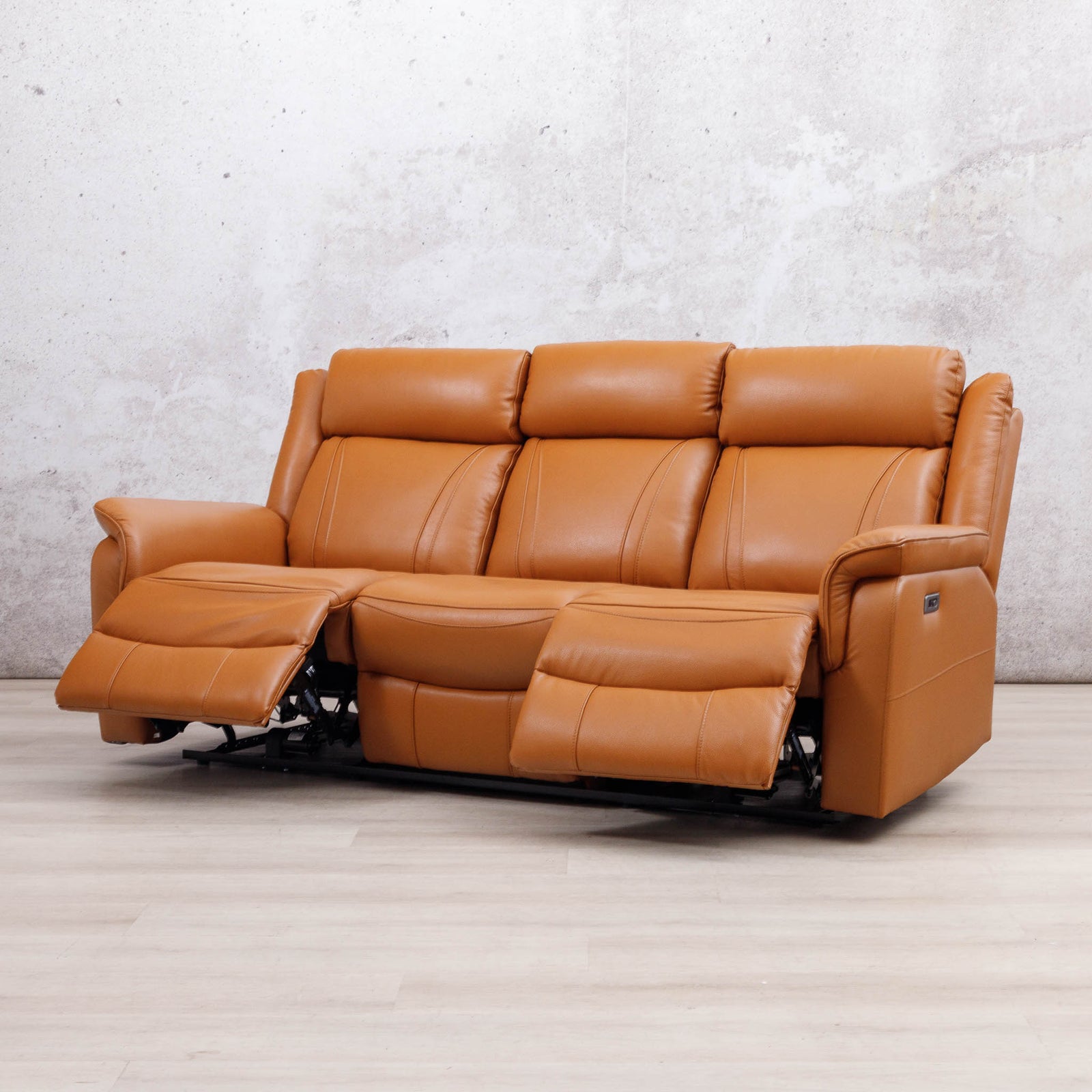 Leather Gallery Carter 3 Seater Leather Recliner in Tan, shown with the centre and right footrests extended.