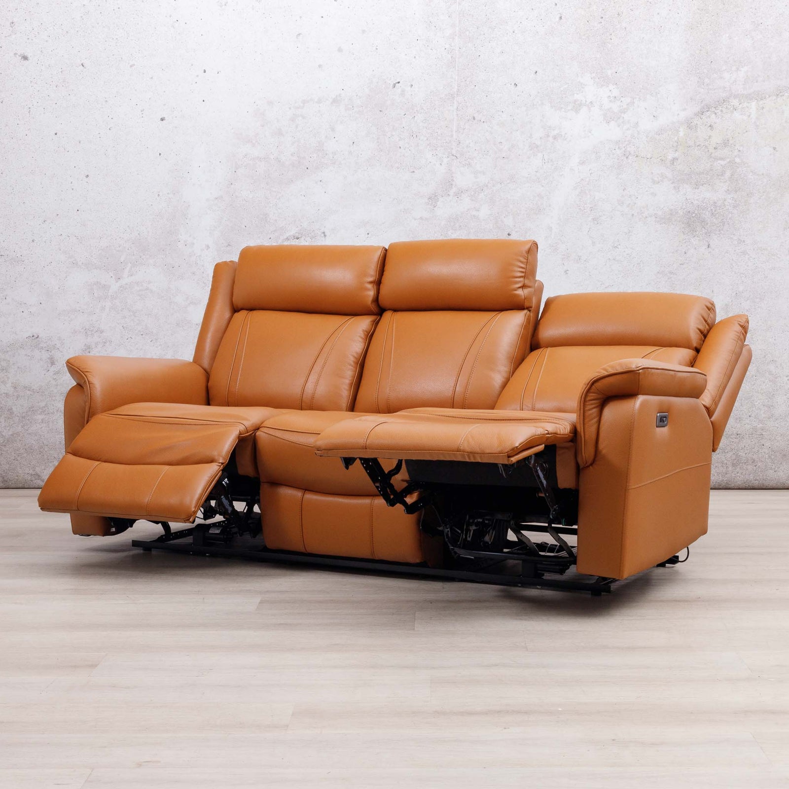 Leather Gallery Carter 3 Seater Leather Recliner in Tan, shown with the centre and left footrests extended.