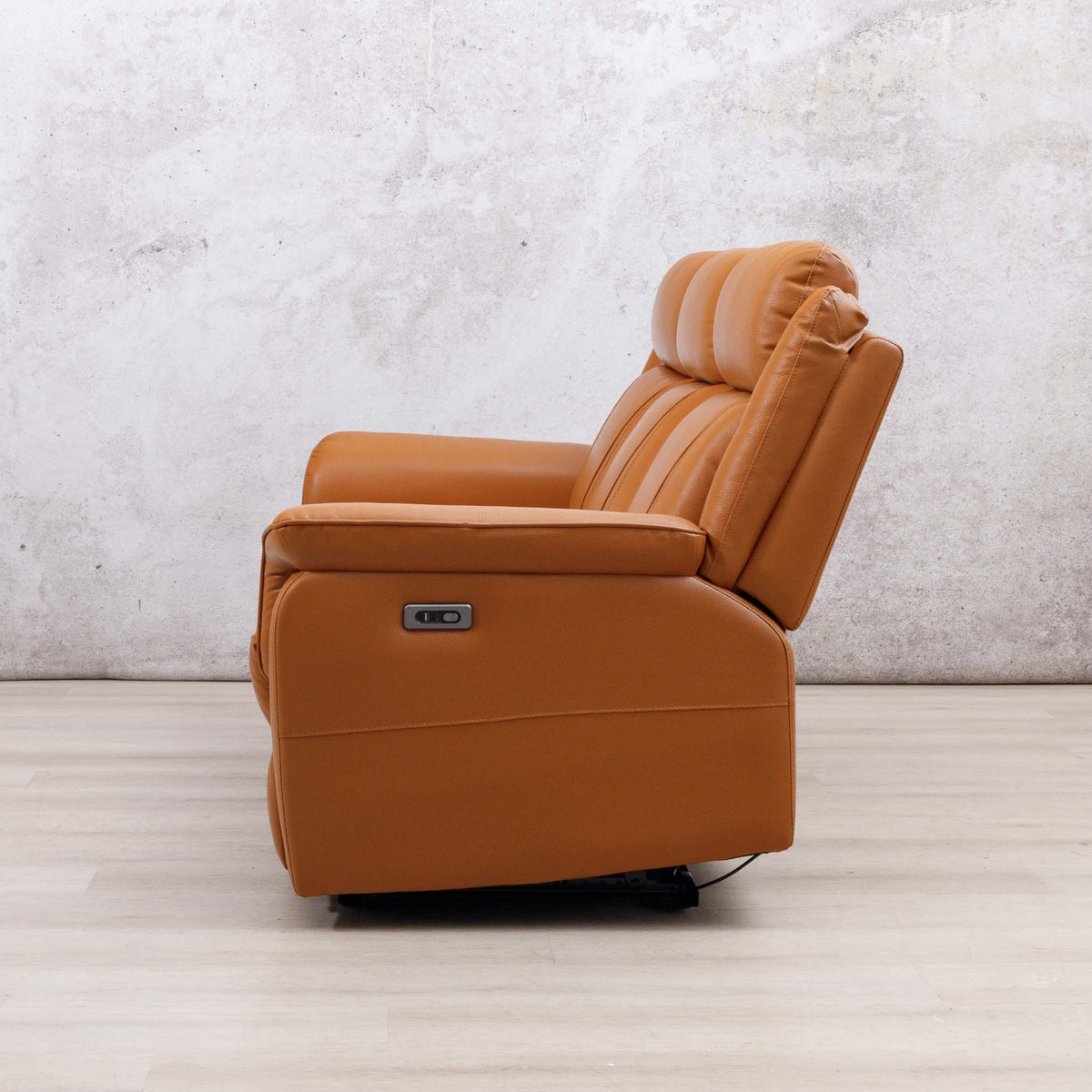 Side view of the Leather Gallery Carter 3 Seater Leather Recliner in Tan, showing the silver KBD brand plate.