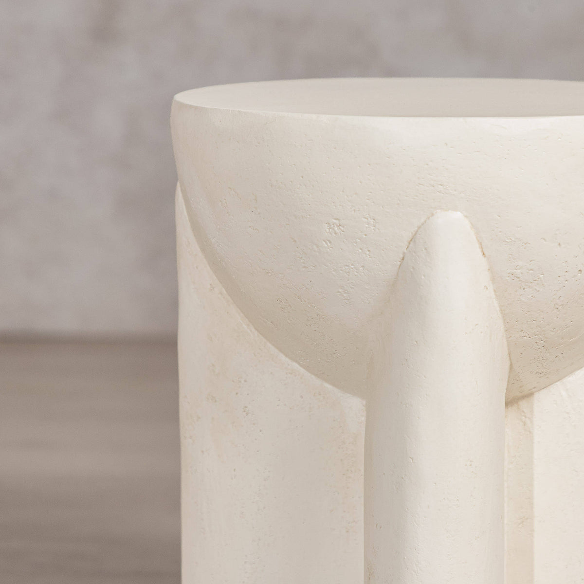 Gallery Everyday Castello Side Table, featuring a sculptural off-white concrete design styled beside a beige sofa.