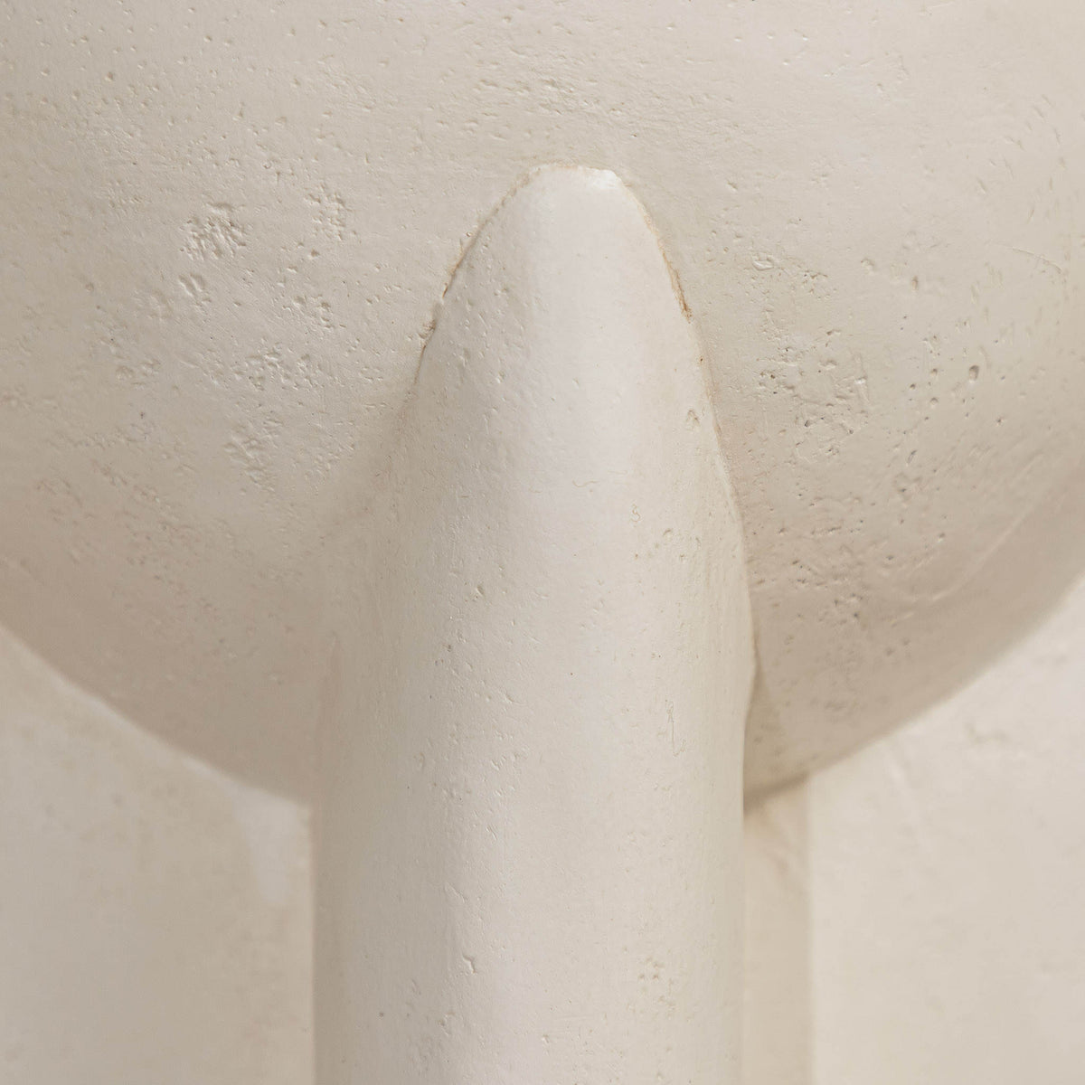 Gallery Everyday Castello Side Table, featuring a sculptural off-white concrete design styled beside a beige sofa.