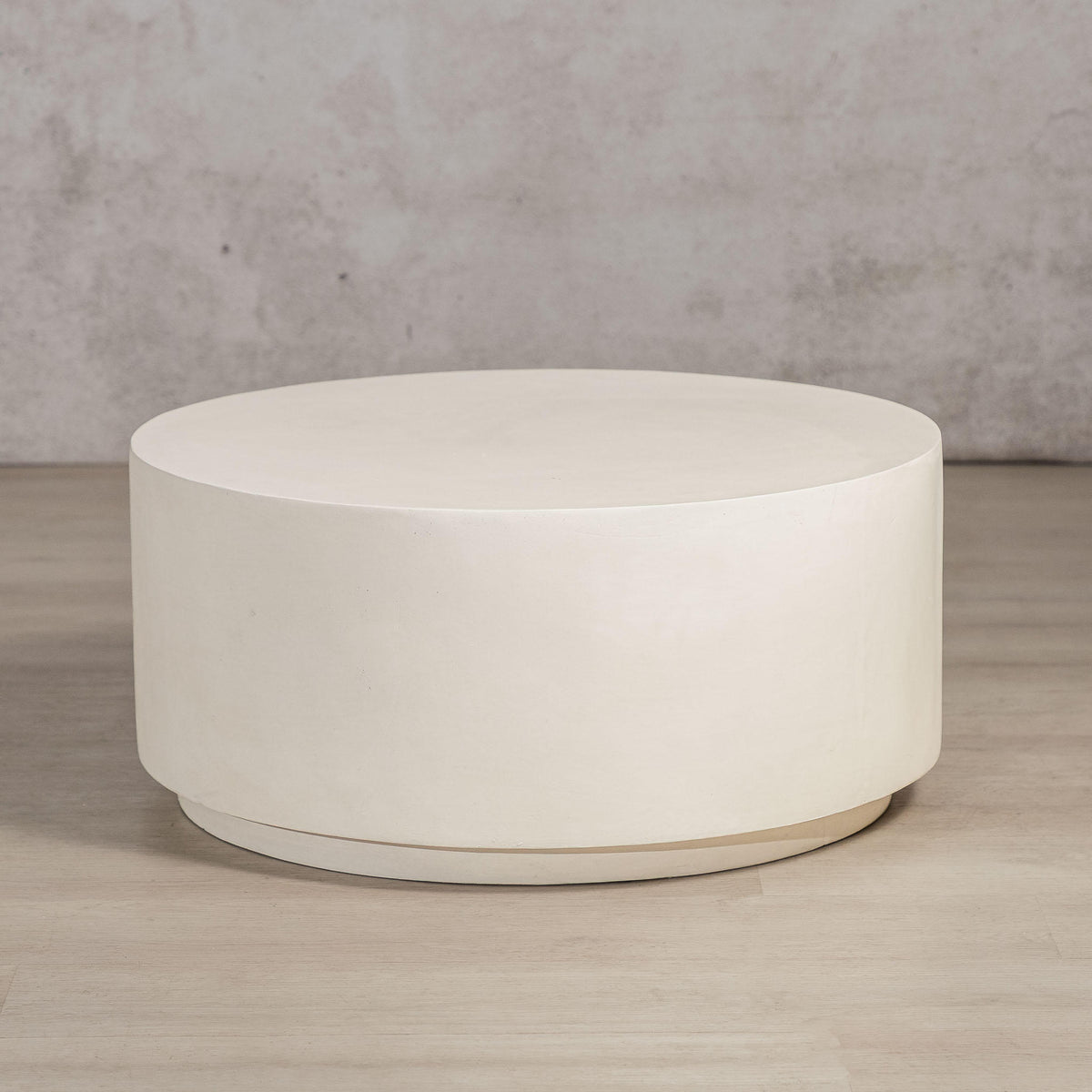 Gallery Everyday Corsano Coffee Table, featuring a round low-profile design in a warm off-white concrete finish.