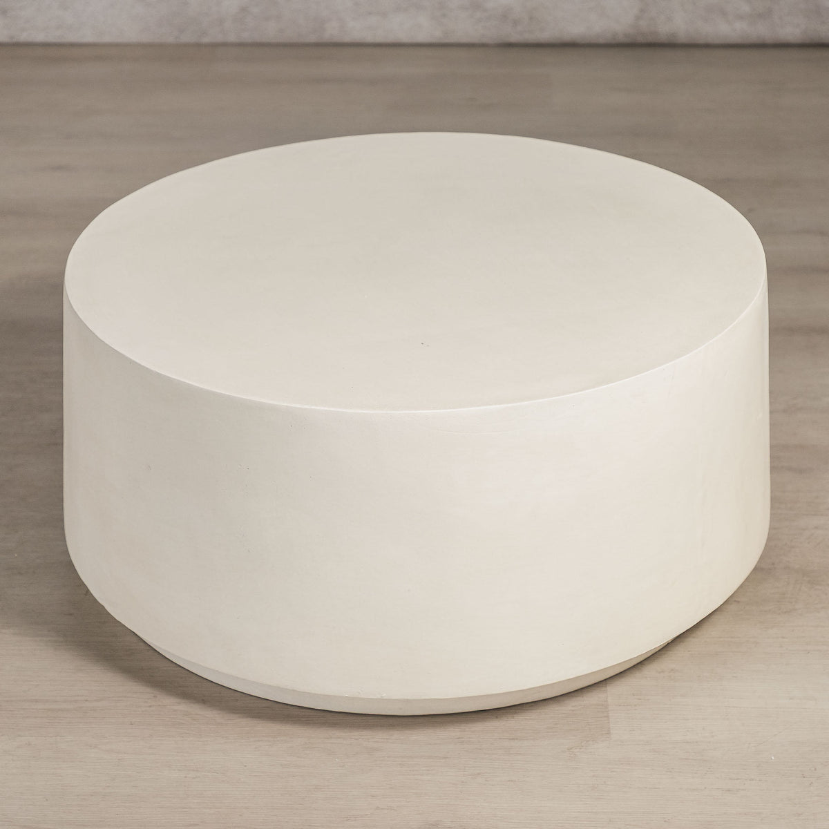 Gallery Everyday Corsano Coffee Table, featuring a round low-profile design in a warm off-white concrete finish.
