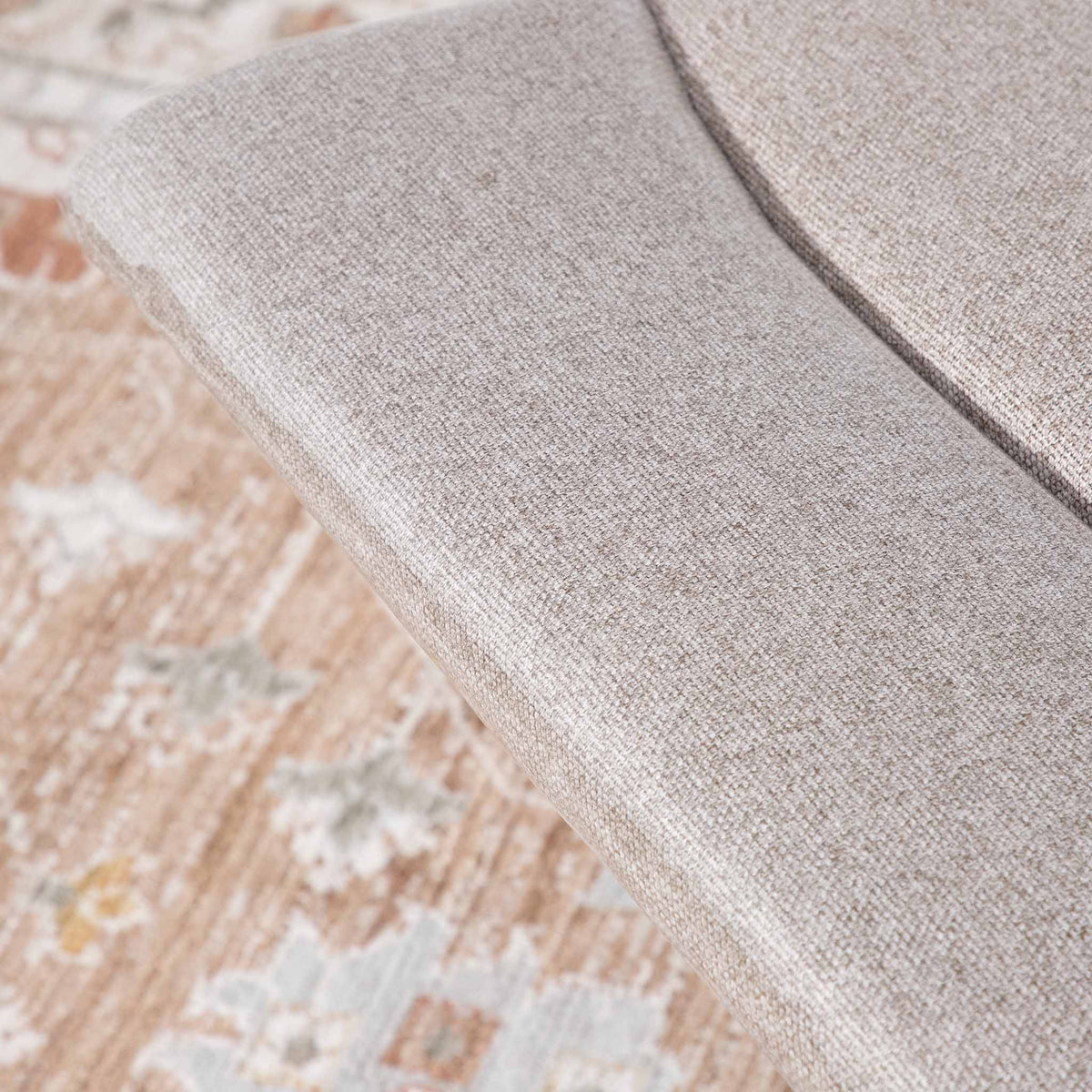 Close-up of the Leather Gallery Dallas Fabric Rocker Recliner Chair in Beige, showing the textured upholstery and curved armrest.