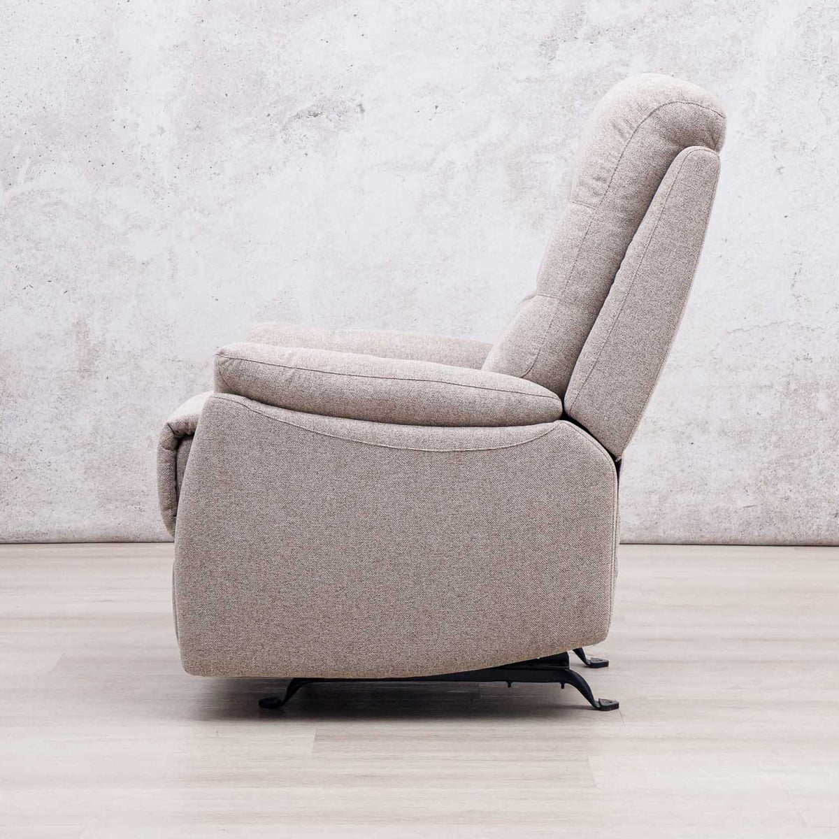 Side view of the Leather Gallery Dallas Fabric Rocker Recliner Chair in Beige, showing its upholstered recliner profile.
