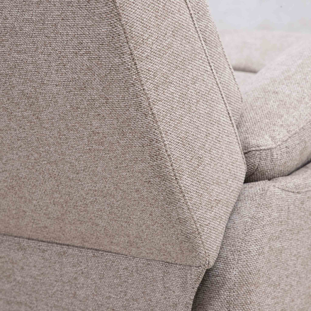 Close-up of the Leather Gallery Dallas Fabric Rocker Recliner Chair in Beige, showing the textured woven upholstery and seam detail.