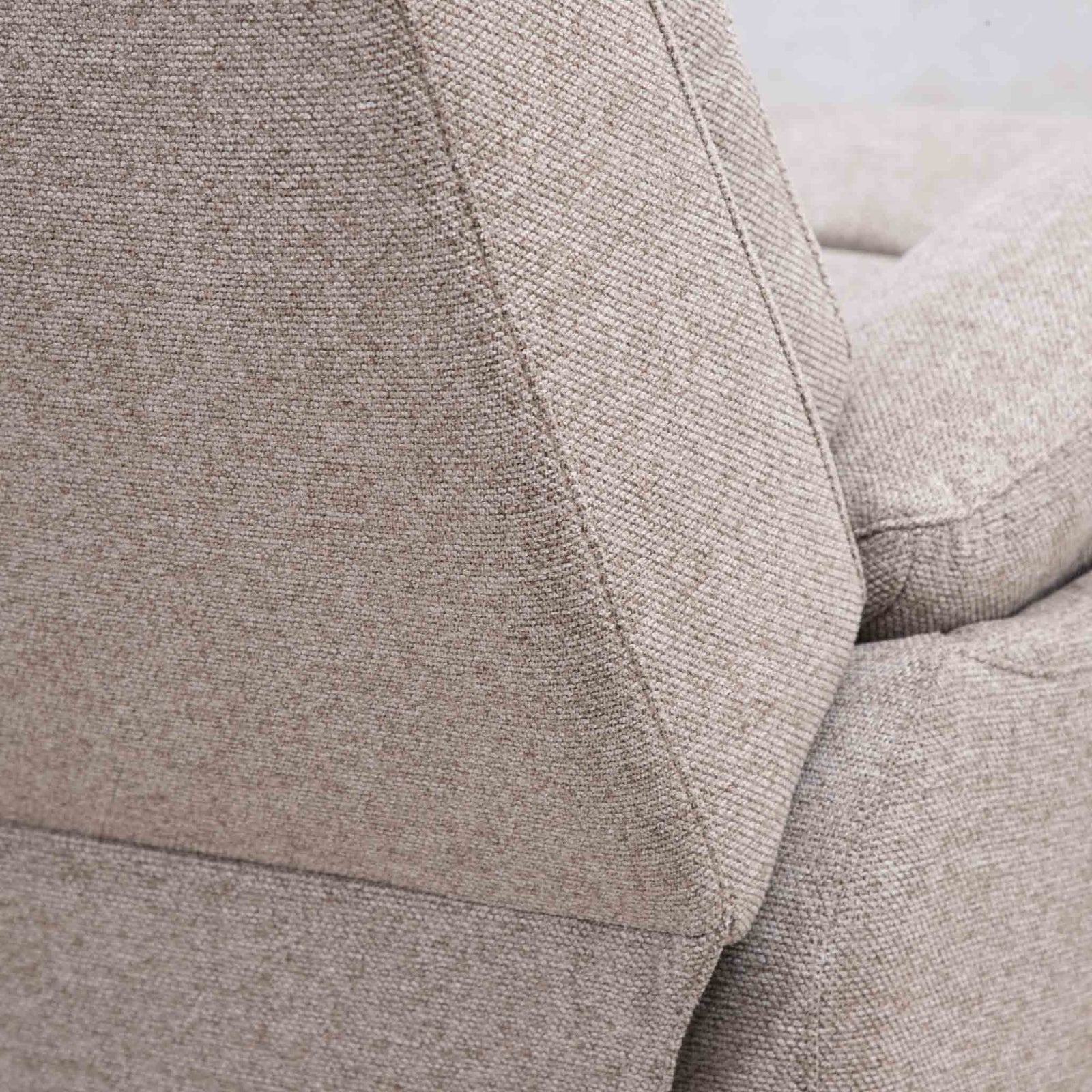 Close-up of the Leather Gallery Dallas Fabric Rocker Recliner Chair in Beige, showing the textured woven upholstery and seam detail.