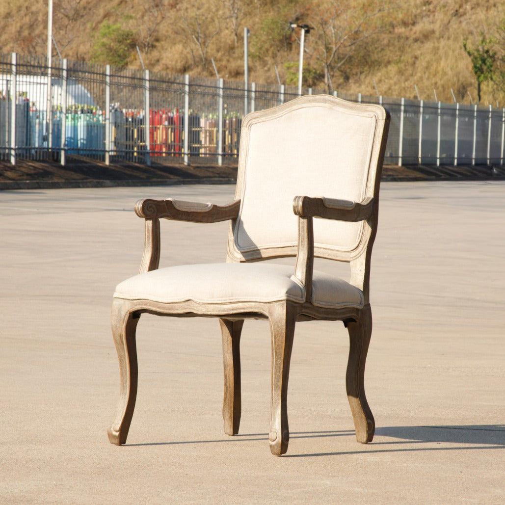 Leather Gallery Duke Carver Dining Chair, featuring a vintage-style frame with beige cushioned seat and backrest.