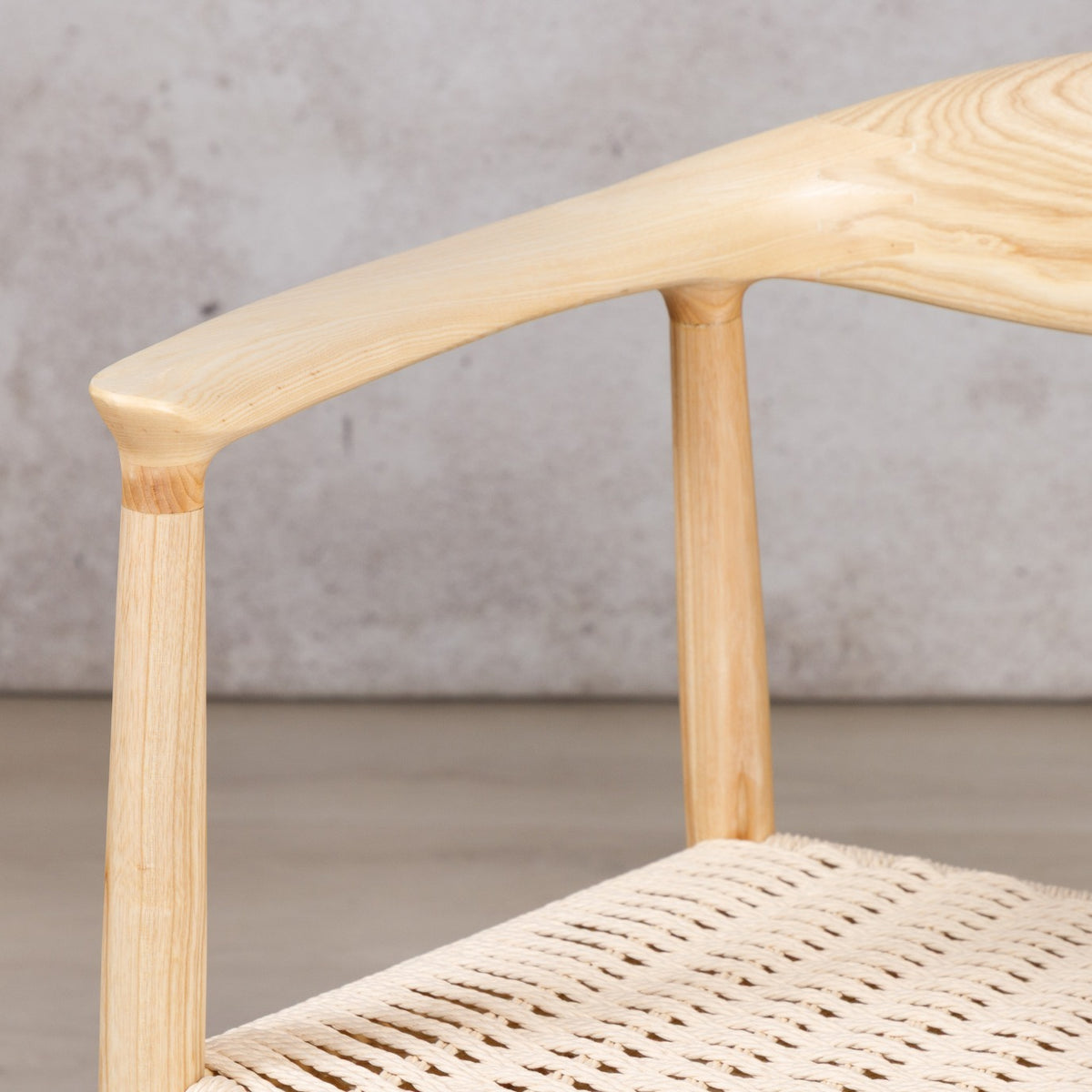 Easton wood dining chair featuring a natural ash wood frame and a textured, handwoven rope seat. dining chairs, modern dining chairs, armchairs close up 