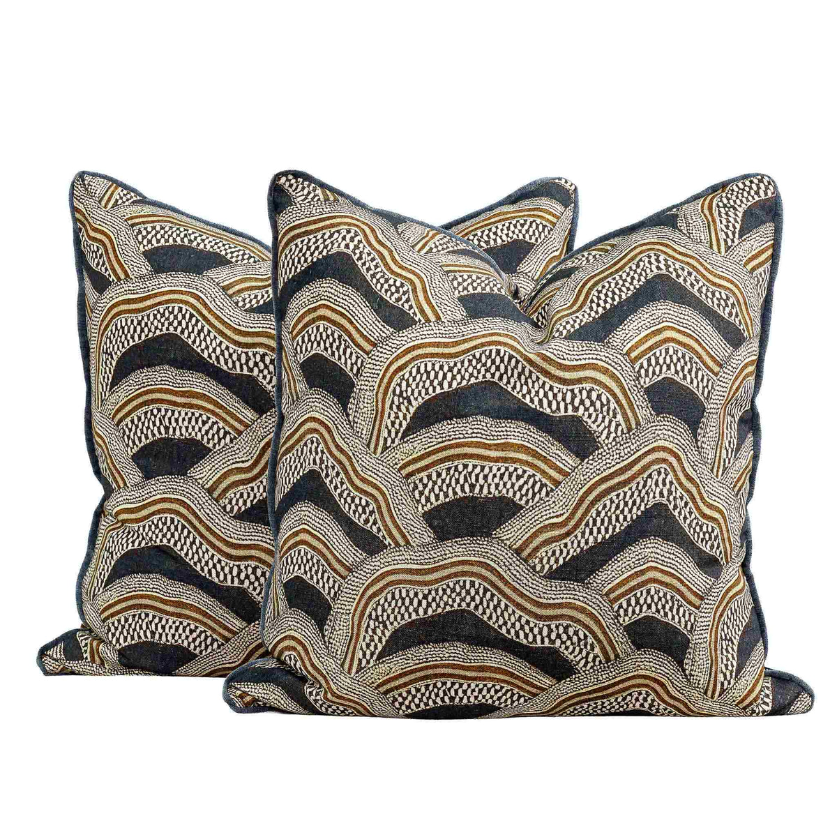 Two Leather Gallery Imperial Partridge Cushions in Volcanic Ash, featuring a matching abstract wave pattern in navy, beige, and brown.
